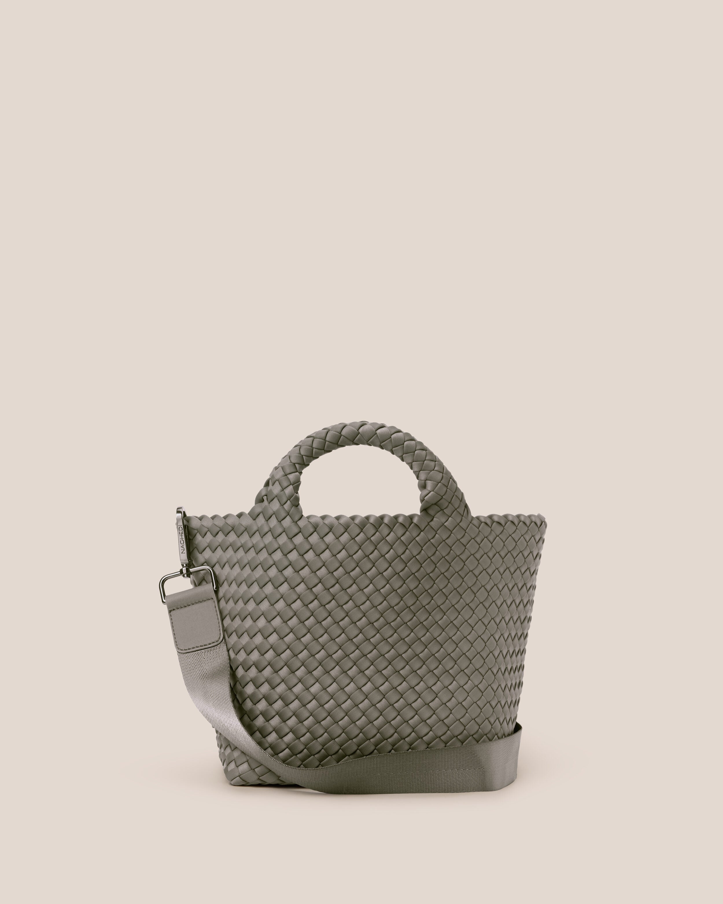 St. Barths Tote in Laurel, a gray-green tone, in handwoven neoprene, featuring an open top, woven top handles, and detachable, adjustable nylon crossbody strap.
