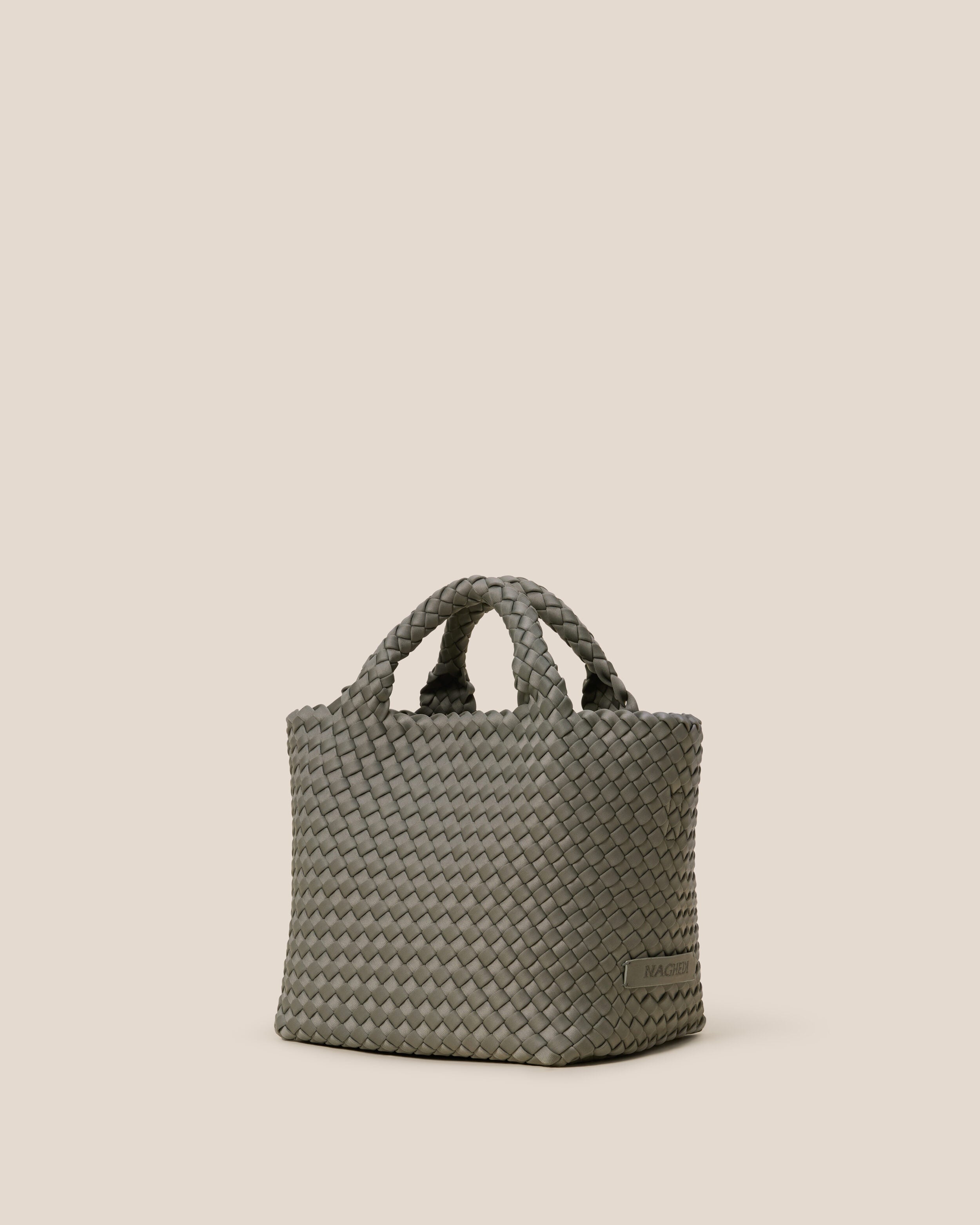 St. Barths Tote in Laurel shown from a side angle, highlighting its handwoven neoprene construction and open top.