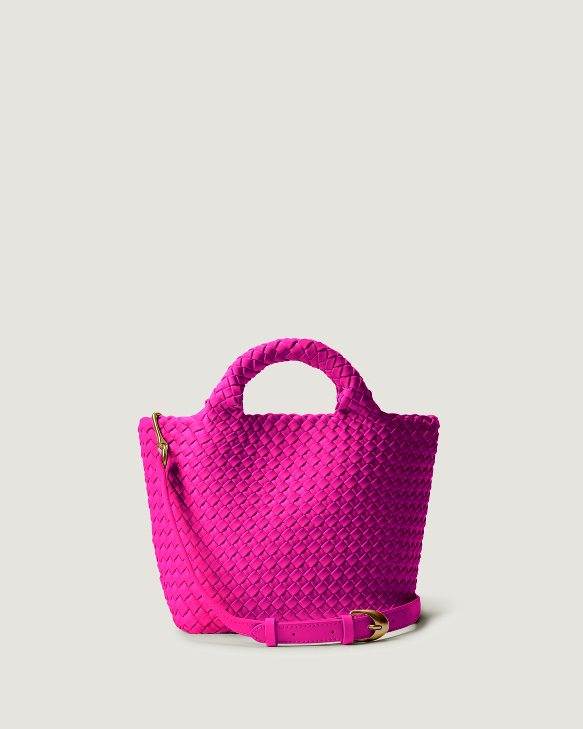 St. Barths Tote in Miami Pink in handwoven neoprene, featuring a magnetic closure, woven top handles, and detachable, adjustable leather crossbody strap.
