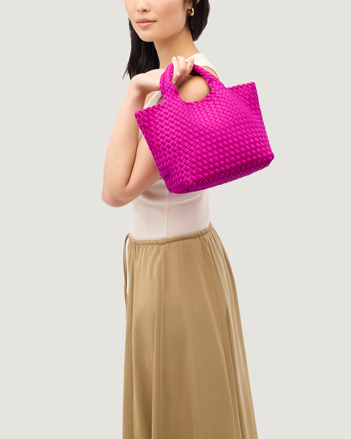 St. Barths Tote in Miami Pink shown on model to illustrate scale and soft silhouette.