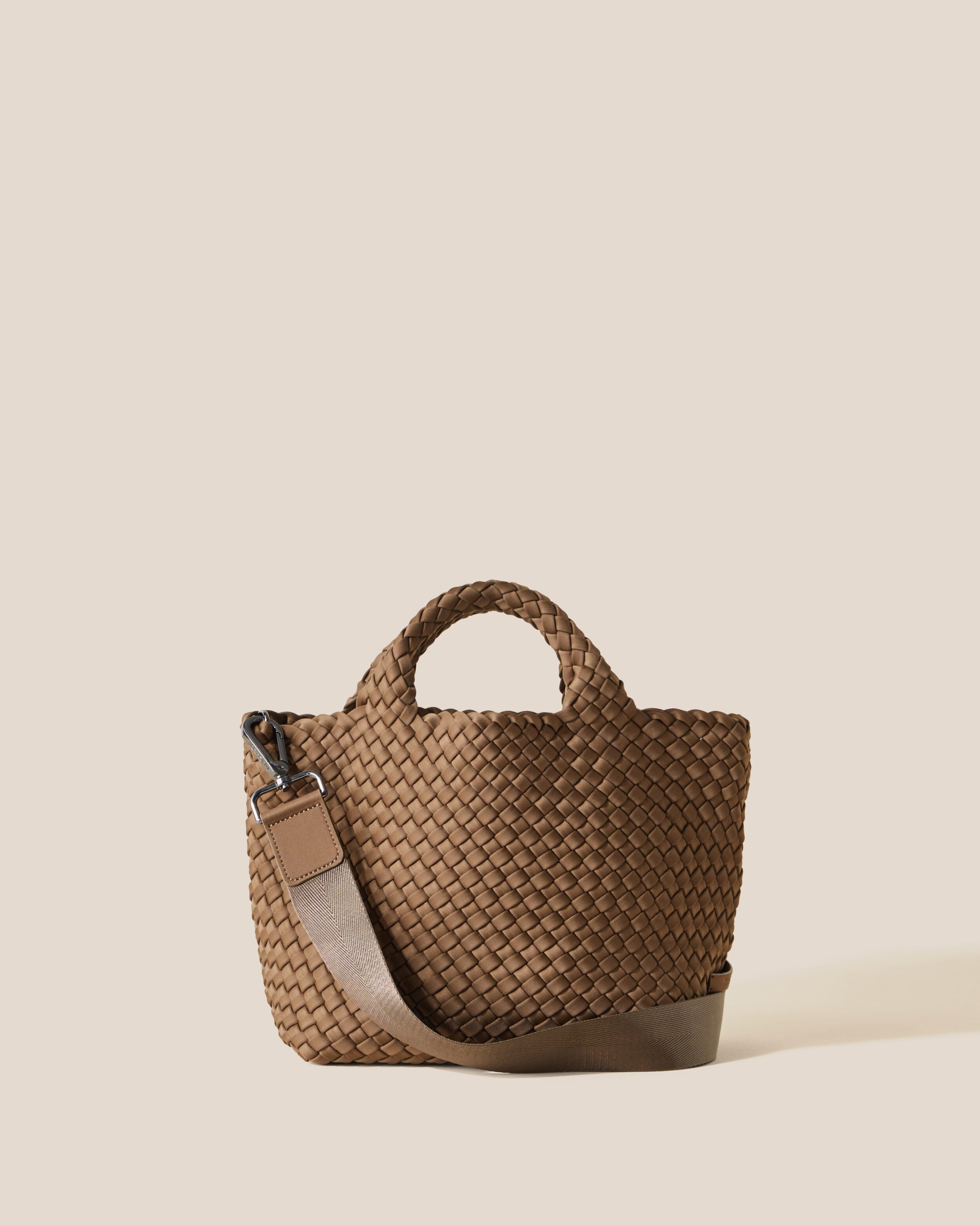St. Barths Tote in Mink, a brown tone, in handwoven neoprene, featuring an open top, woven top handles, and detachable, adjustable nylon crossbody strap.