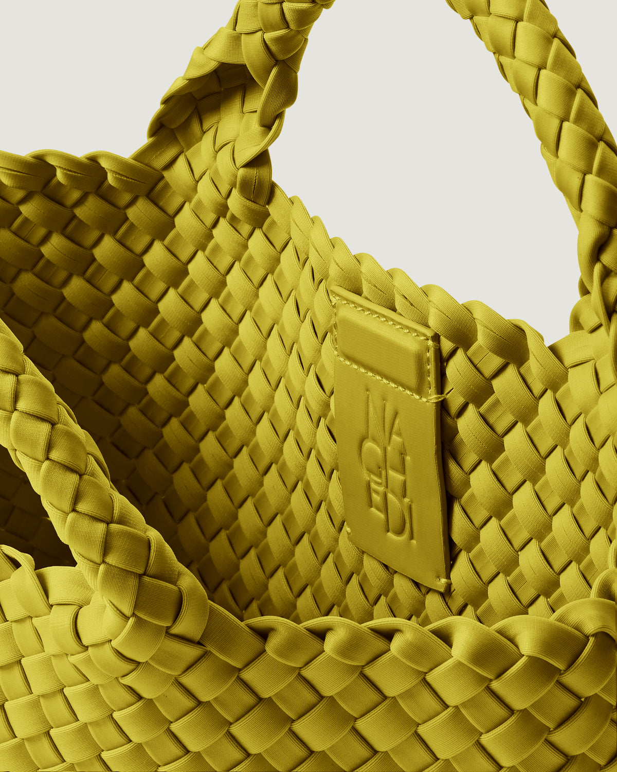 Interior close-up of St. Barths Tote in Ochre showing its magnetic snap closure, and unlined interior.