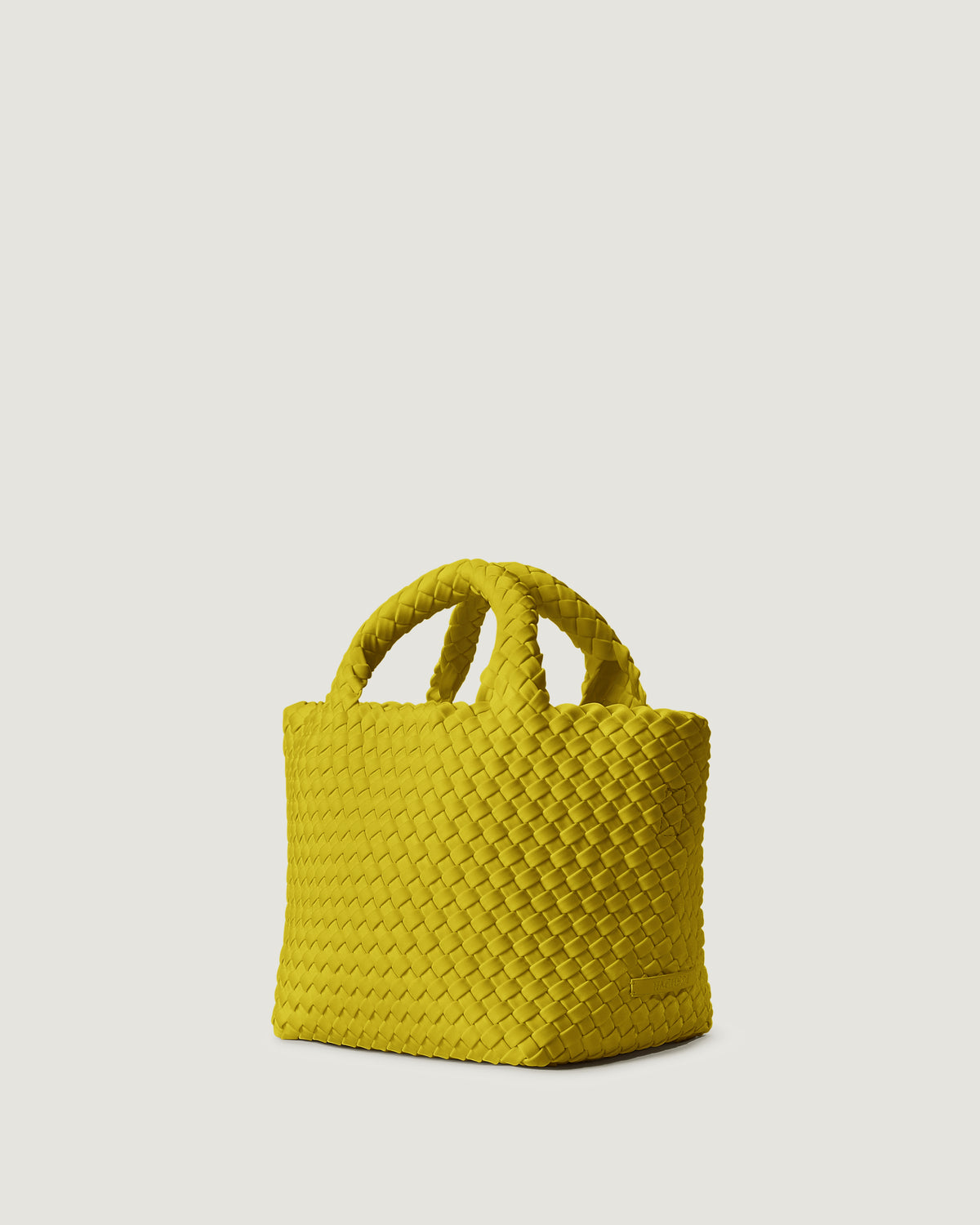 St. Barths Tote in Ochre shown from a side angle, highlighting its handwoven neoprene construction and open top with magnetic snap closure.
