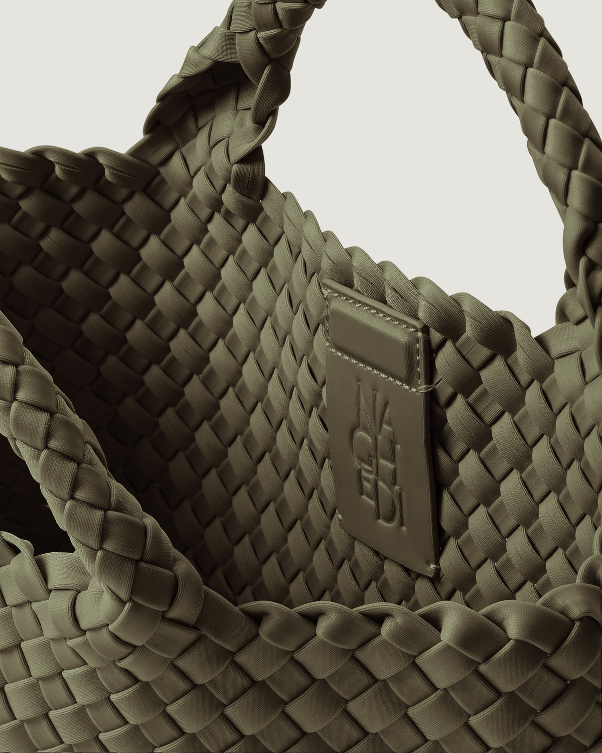 Interior close-up of St. Barths Tote in Olive showing its magnetic snap closure, and unlined interior.