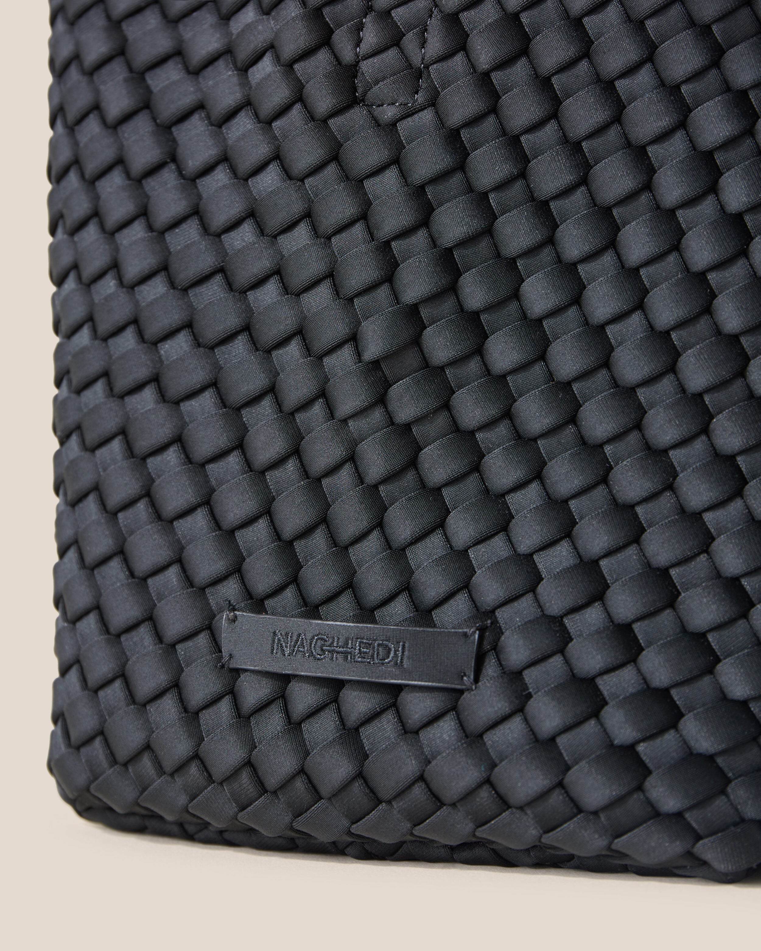 Close-up of stamped NAGHEDI logo on St. Barths Tote in Onyx.