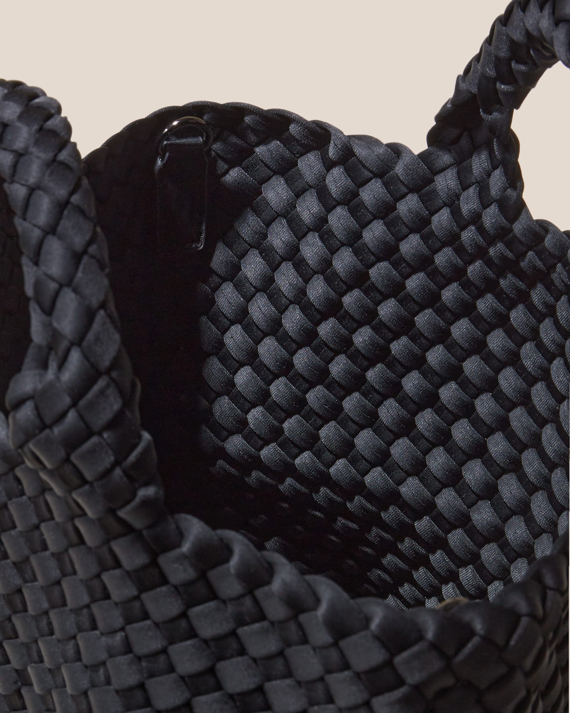 Interior close-up of St. Barths Tote in Onyx showing its open top, and unlined interior.