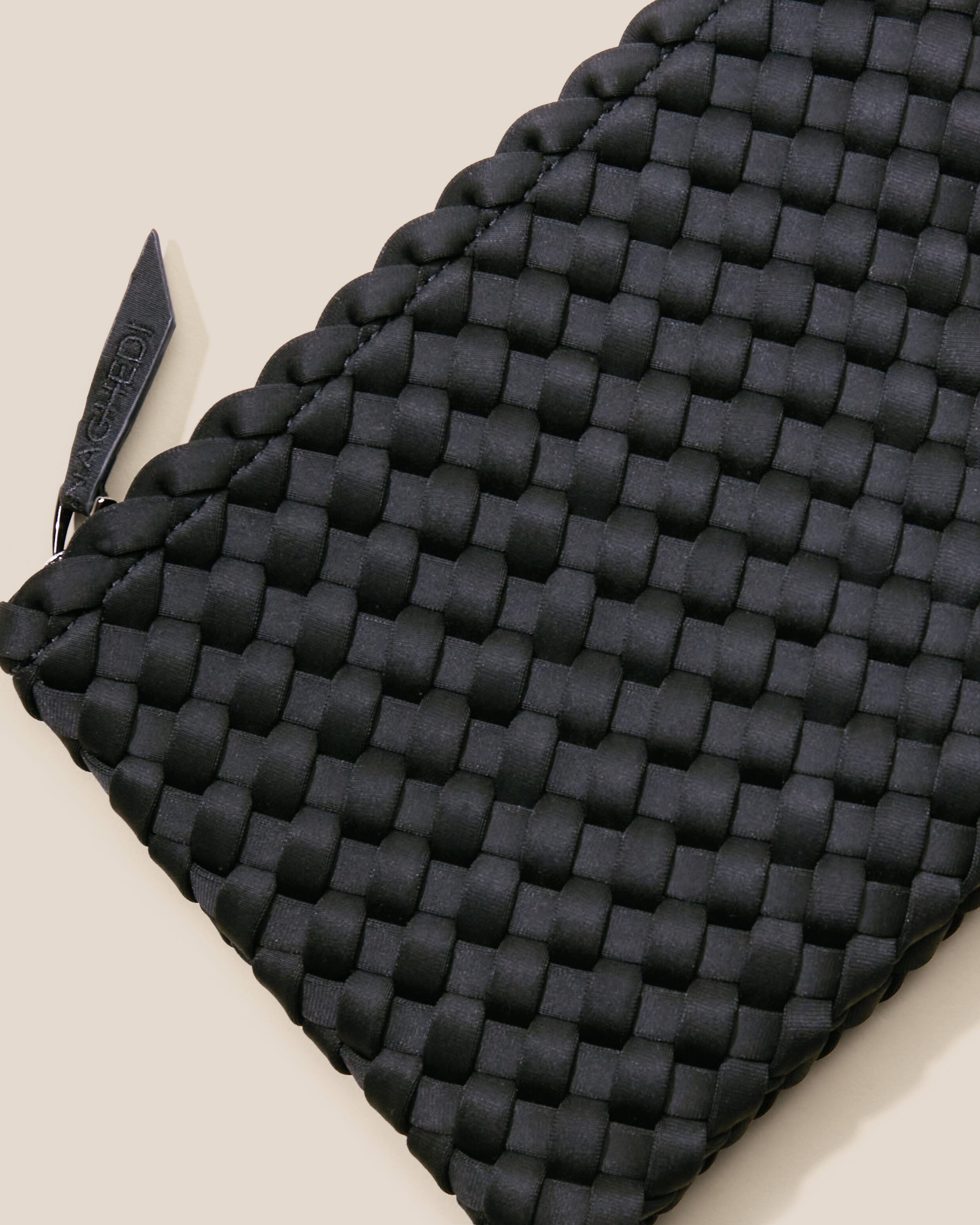 Close-up of included matching woven zippered pouch.