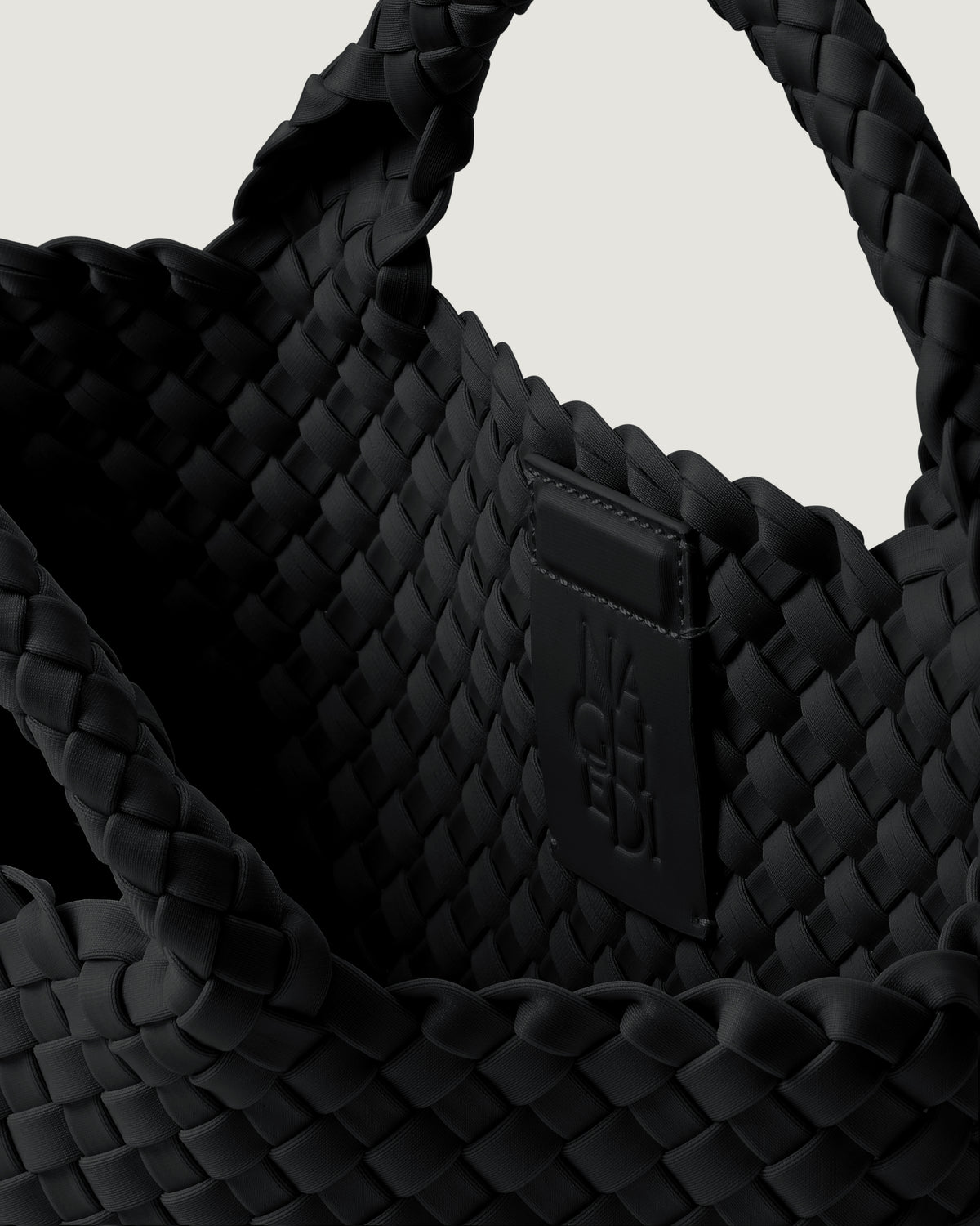 Interior close-up of St. Barths Tote in Onyx showing its magnetic snap closure, and unlined interior.