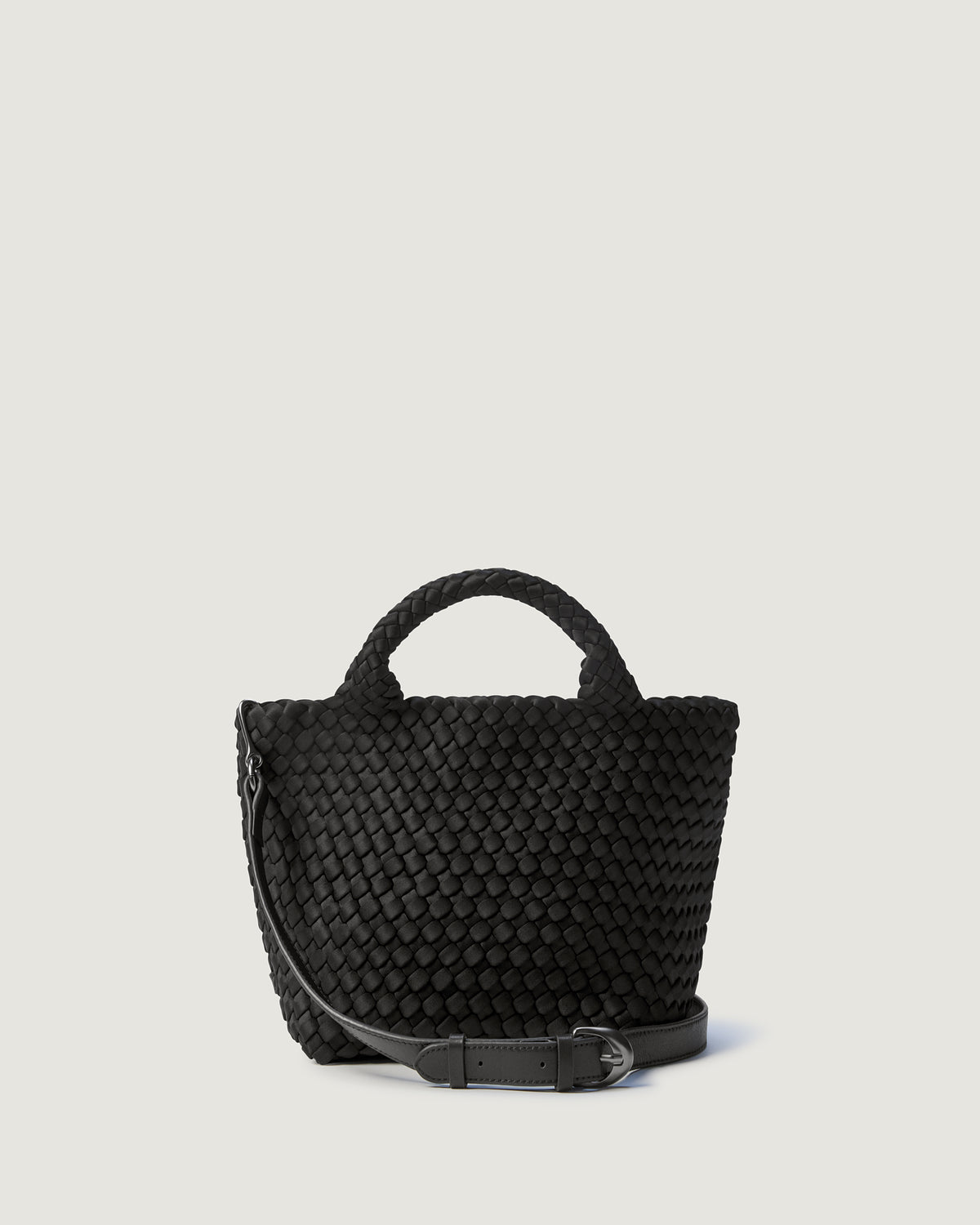 St. Barths Tote in Onyx in handwoven neoprene, featuring a magnetic closure, woven top handles, and detachable, adjustable leather crossbody strap.