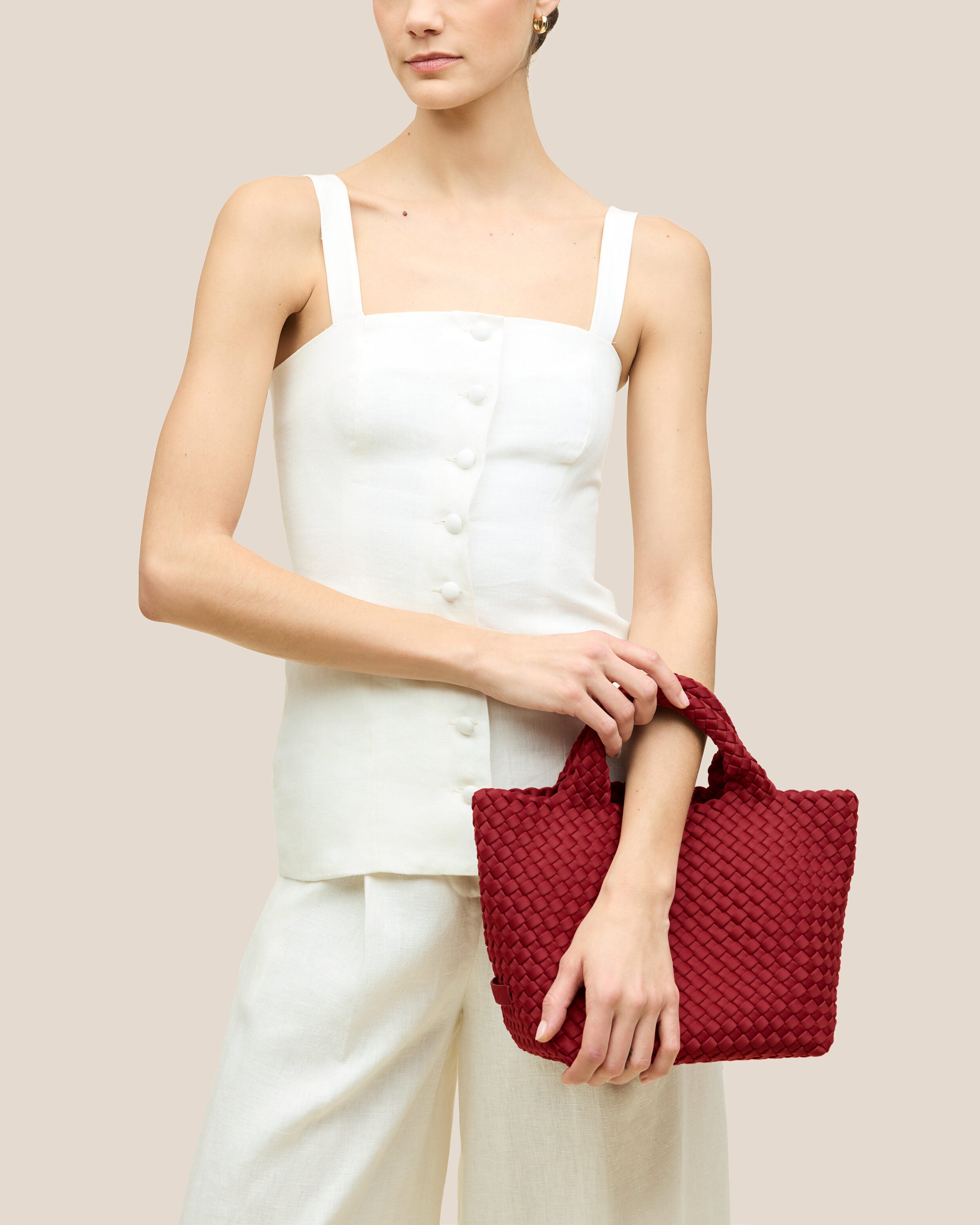 St. Barths Tote in Rosso shown on model to illustrate scale and soft silhouette.
