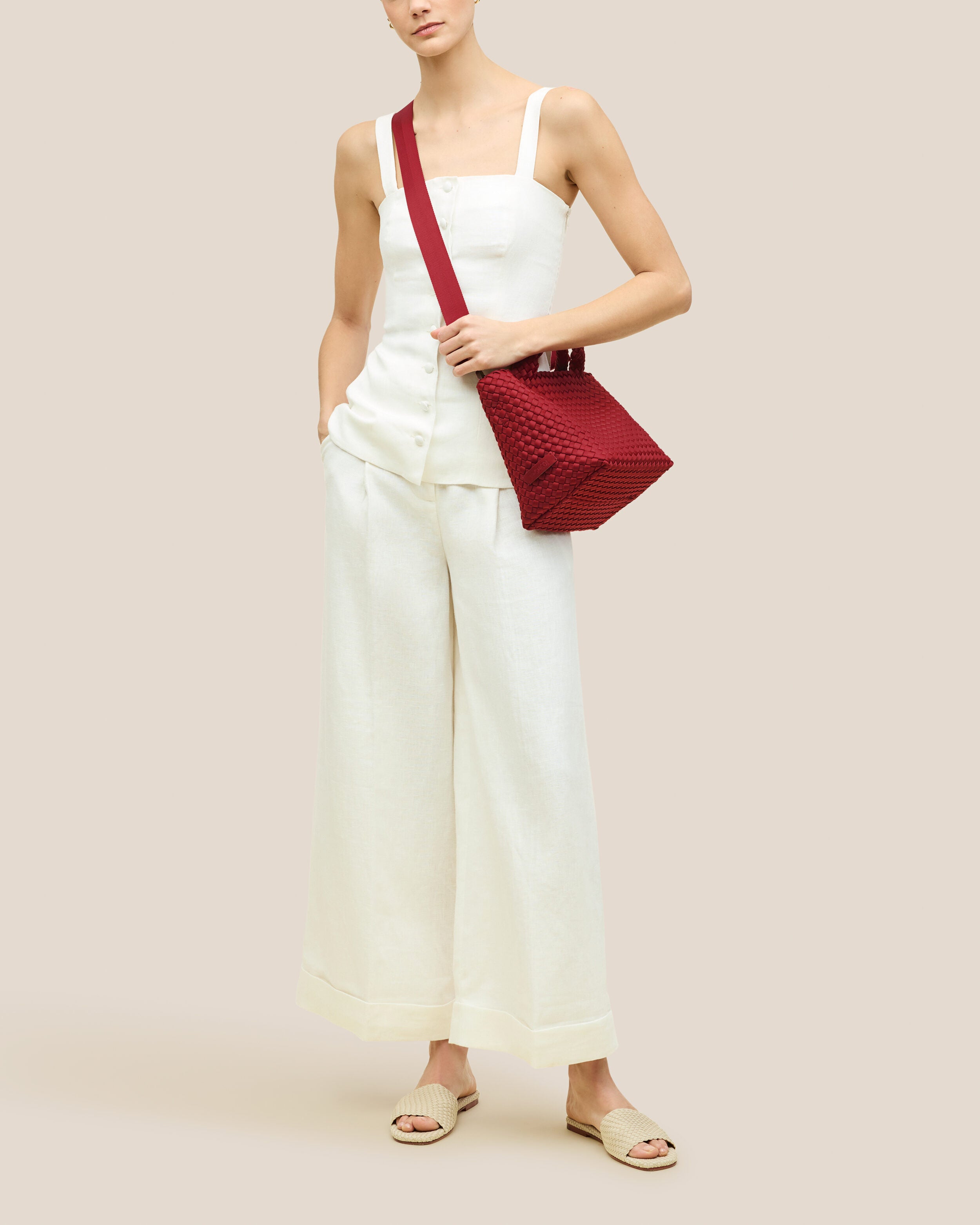 St. Barths Tote in Rosso shown on model to illustrate scale and soft silhouette.