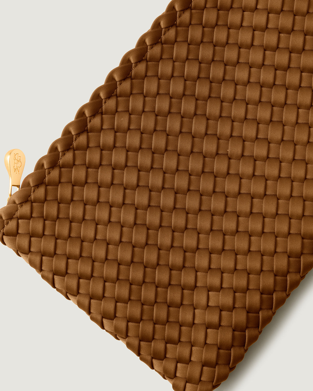 Close-up of included matching woven zippered pouch.