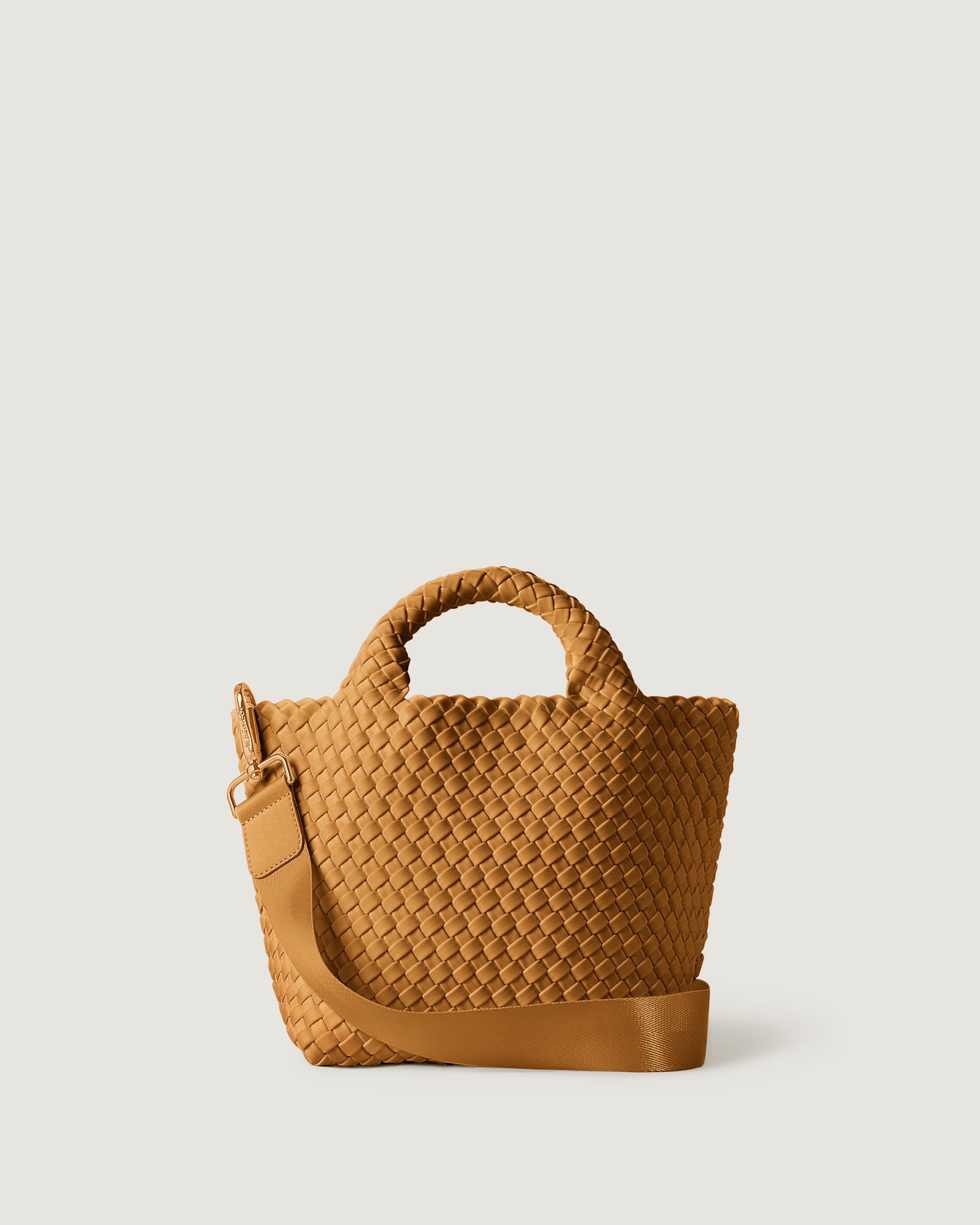 St. Barths Tote in Turmeric, handwoven in golden chartreuse neoprene. Featuring an open top, adjustable shoulder strap, and woven top handles.