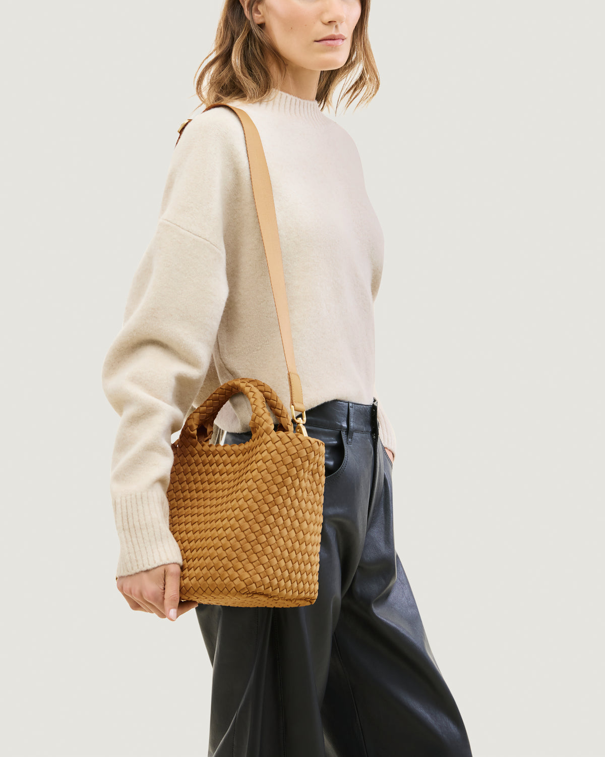 St. Barths Tote in Turmeric shown on model to illustrate scale and soft silhouette and length of adjustable shoulder strap.