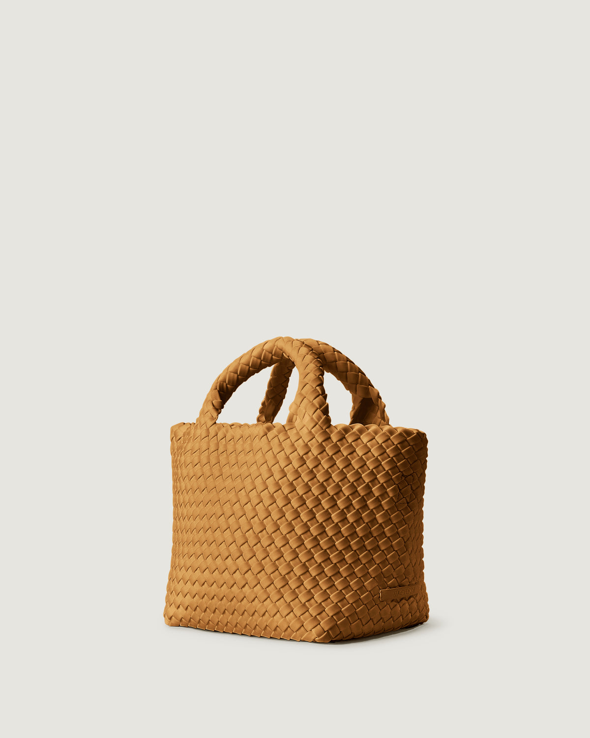 Side view of St. Barths Tote in Turmeric, handwoven in golden chartreuse neoprene. Featuring an open top, and woven top handles.