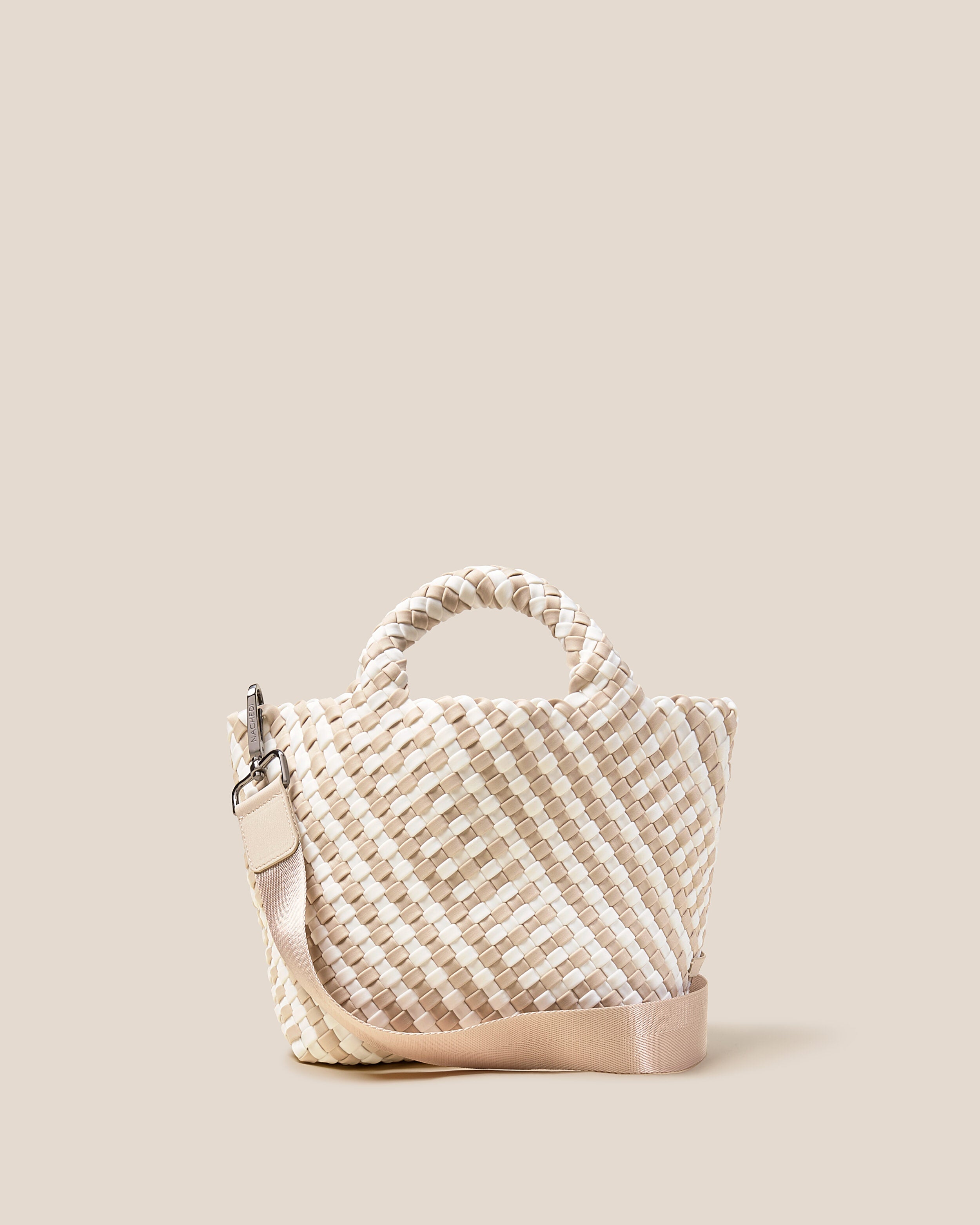 St. Barths Tote in Mykonos, a cream and ivory tone, in handwoven neoprene, featuring an open top, woven top handles, and detachable, adjustable nylon crossbody strap.