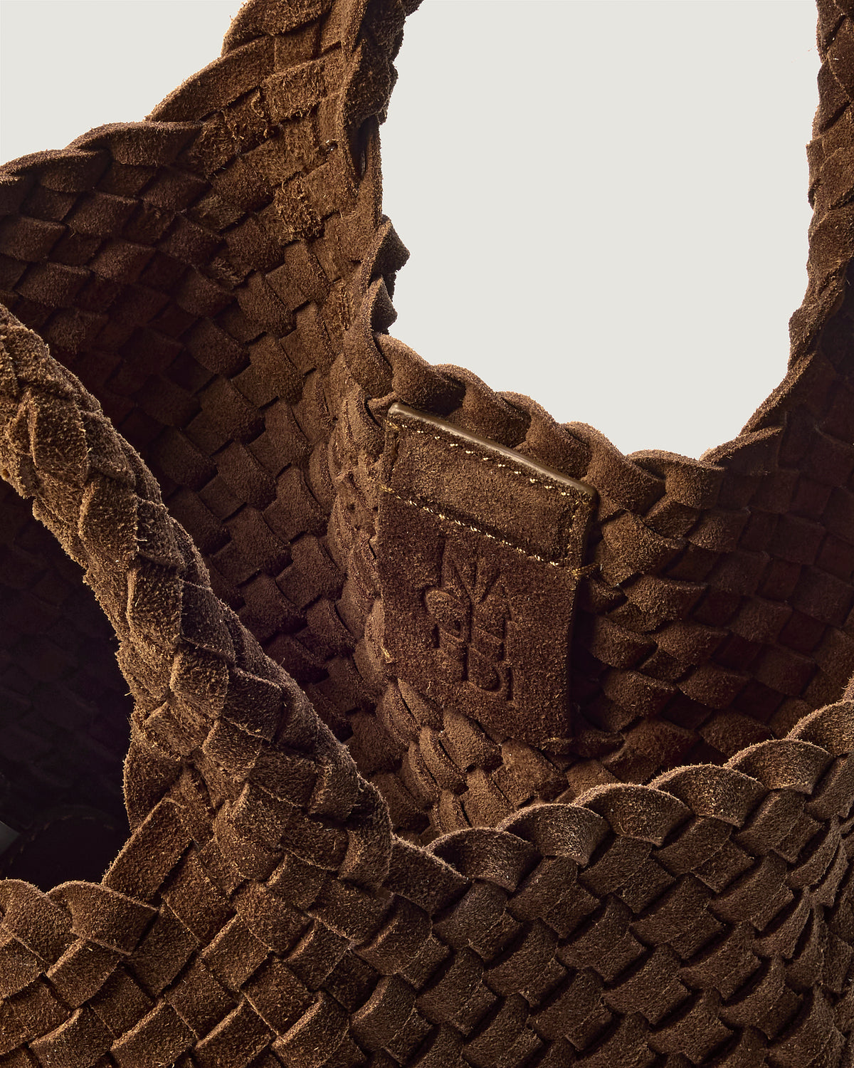 Interior close-up of St. Barths Tote in Teak showing its magnetic snap closure, and unlined interior.
