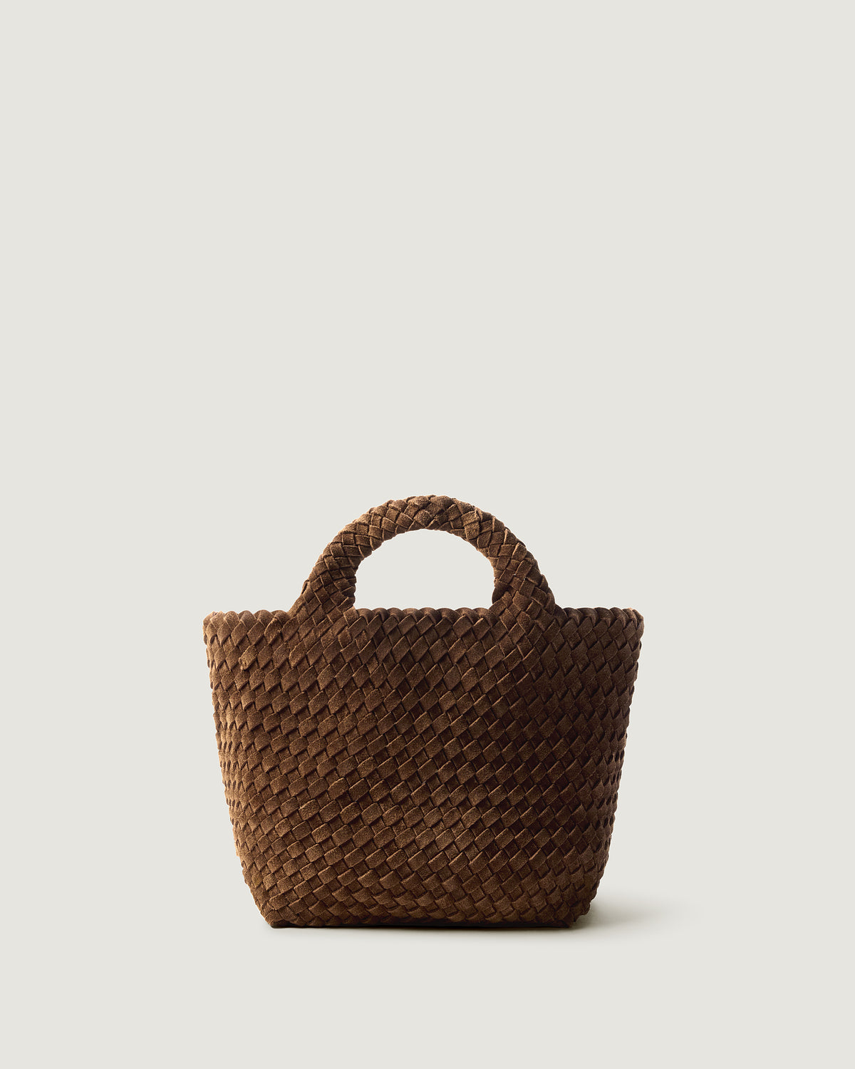 St. Barths Tote in Teak, a saddle brown tone, in handwoven suede, featuring a magnetic closure, and woven top handles.