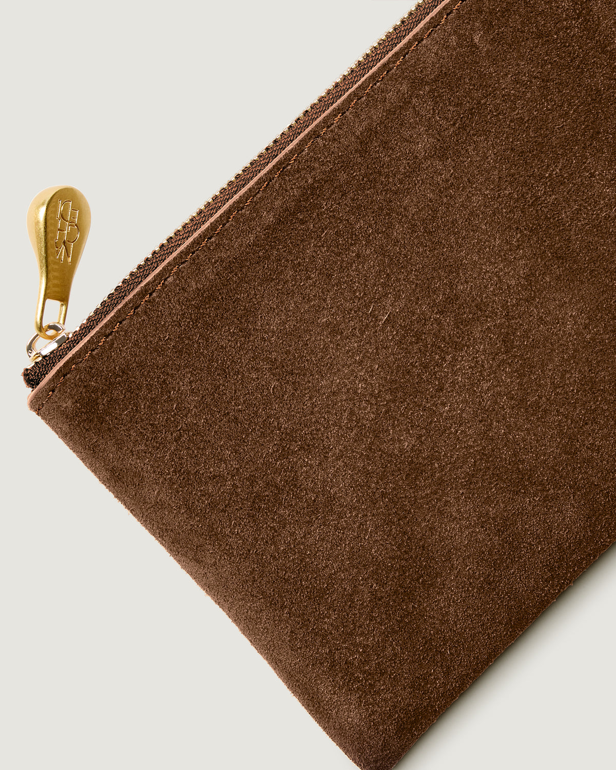 Close-up of included matching suede zippered pouch.