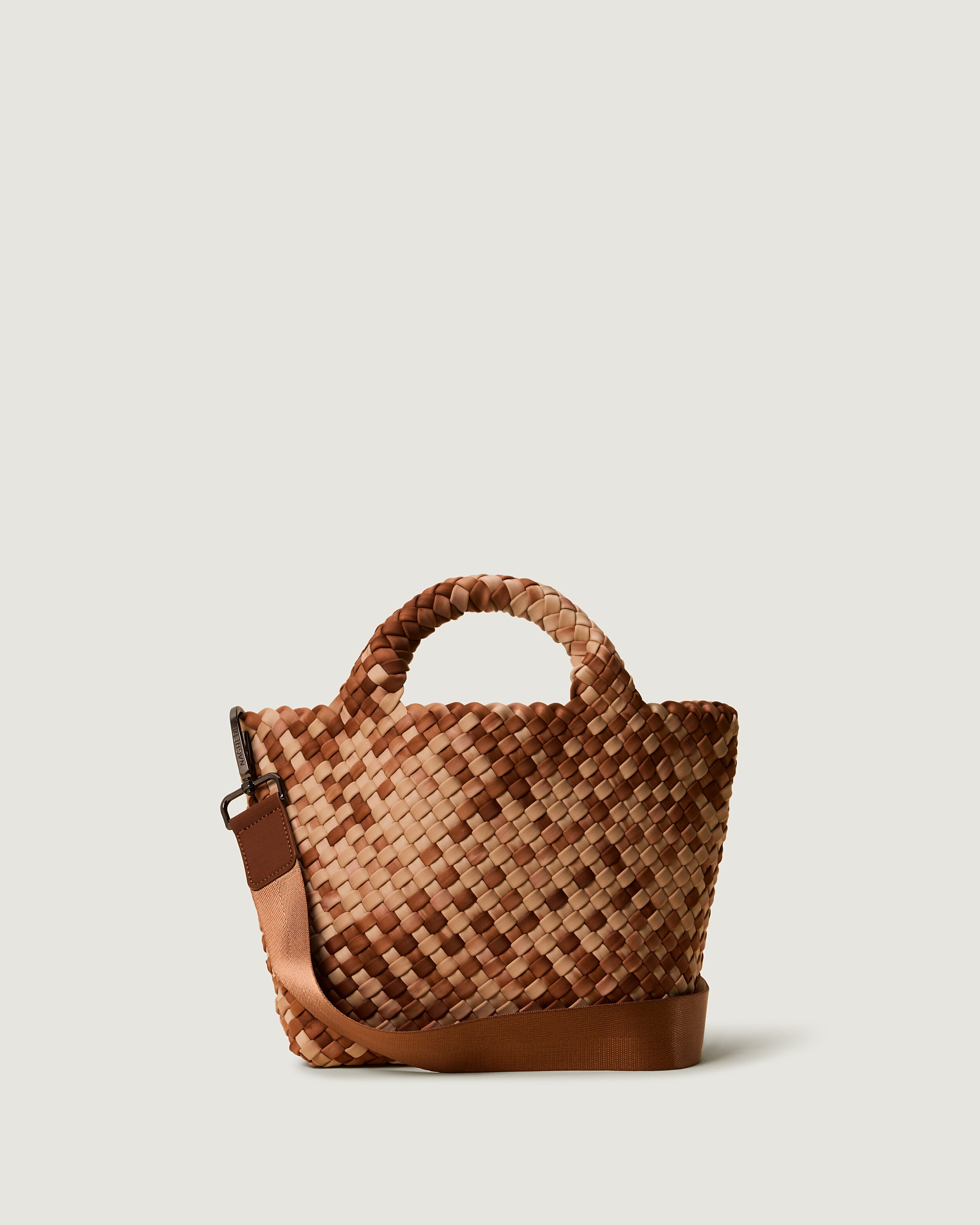 St. Barths Tote in Fez, a camel brown and saddle brown tone, in handwoven neoprene, featuring an open top, woven top handles, and detachable, adjustable nylon crossbody strap.