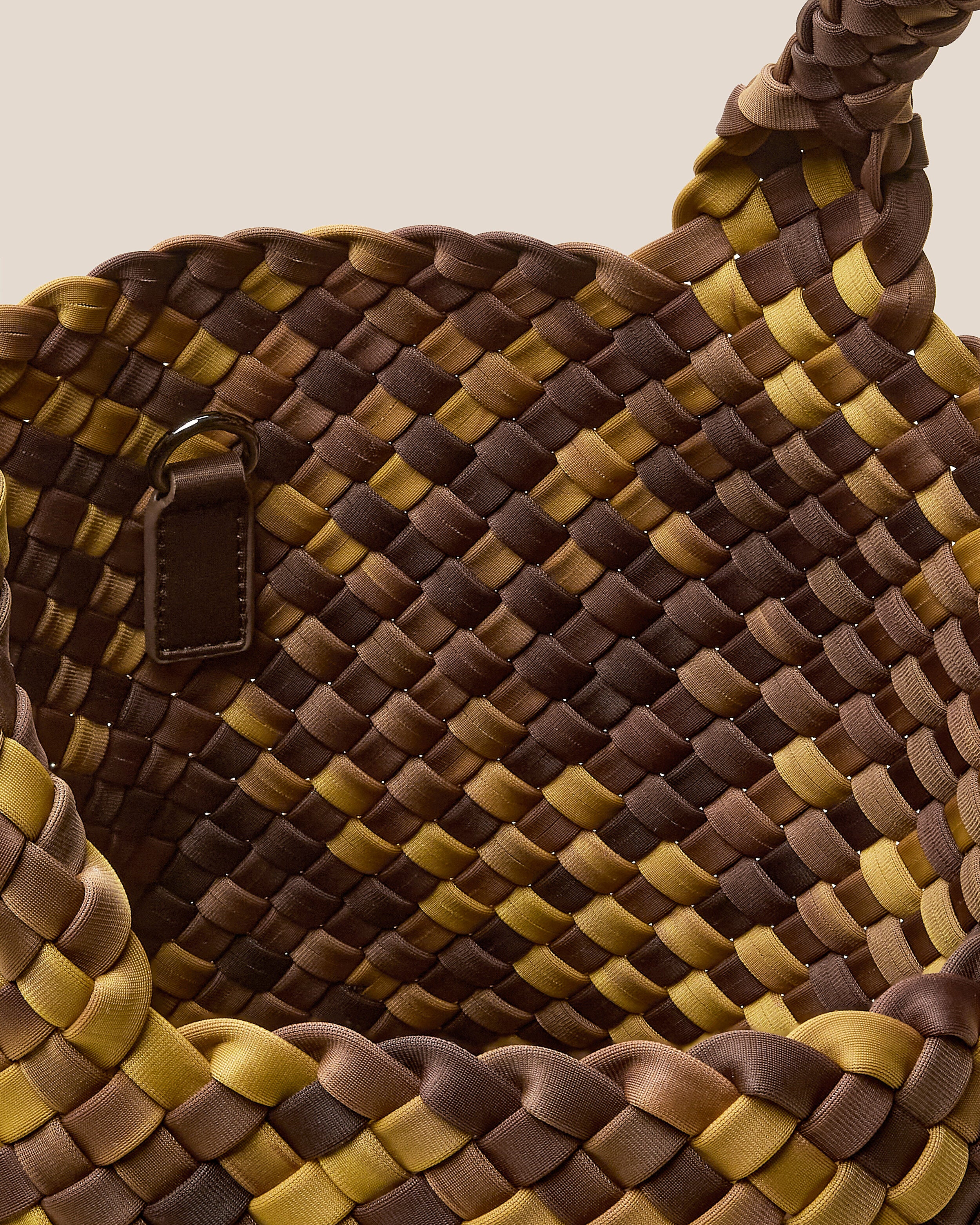 Interior close-up of St. Barths Tote in Tortoiseshell showing its open top, and unlined interior.