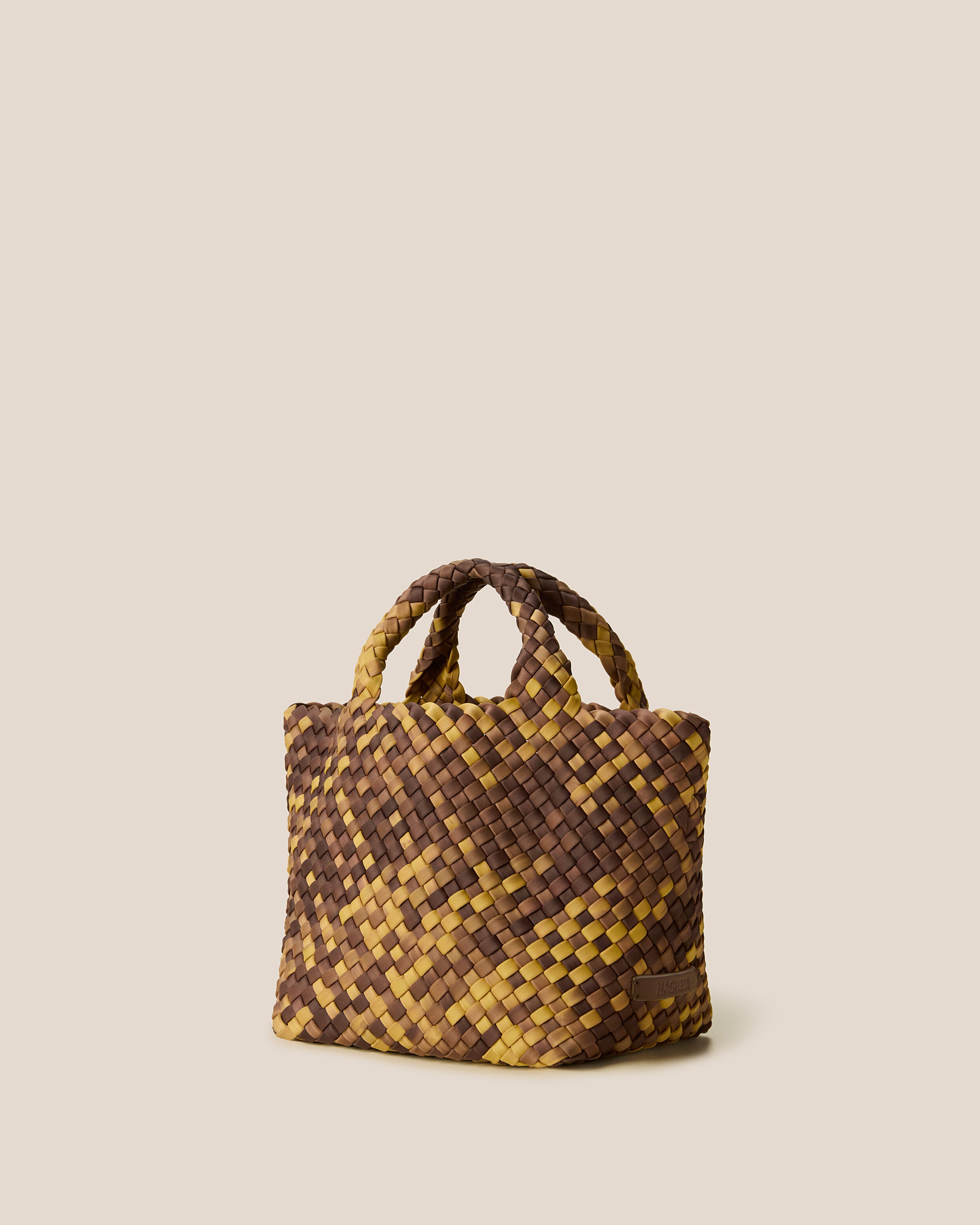 St. Barths Tote in Tortoiseshell shown from a side angle, highlighting its handwoven neoprene construction and open top.