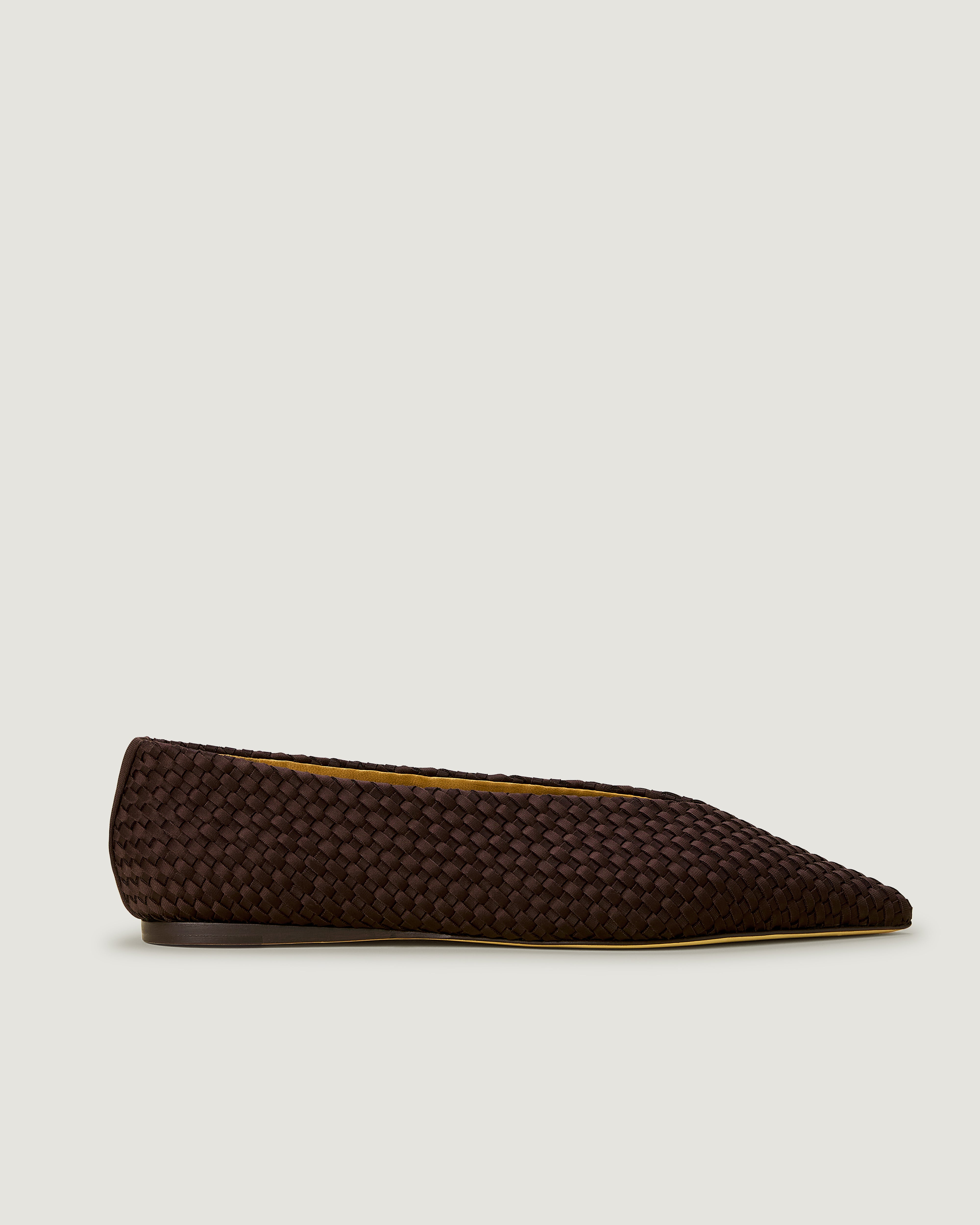 Side view of Strada Flat in Chocolate, a dark chocolate brown tone, featuring a closed toe and pointed silhouette.