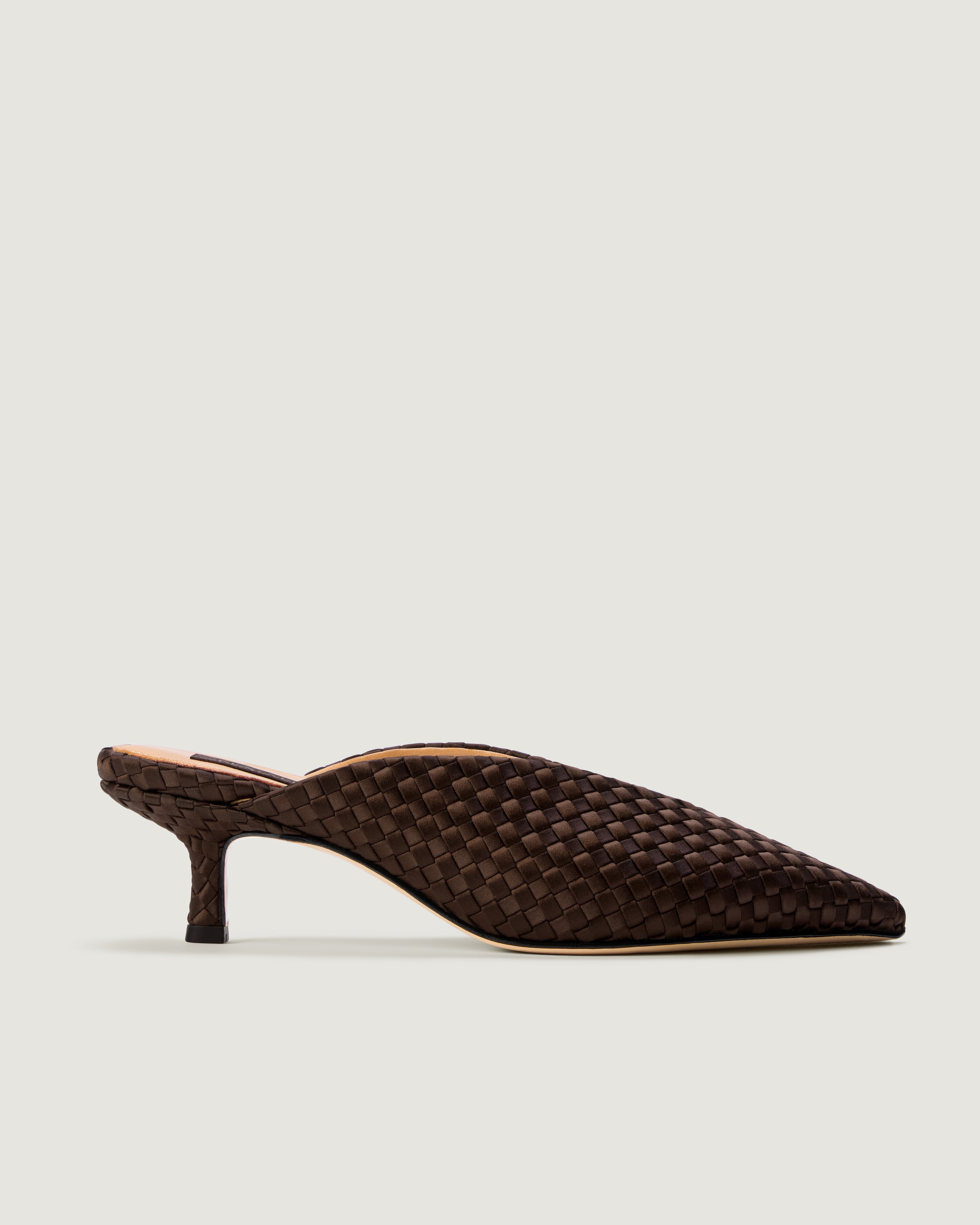 Side view of Strada in Chocolate, a deep brown tone, featuring a closed toe and pointed silhouette.