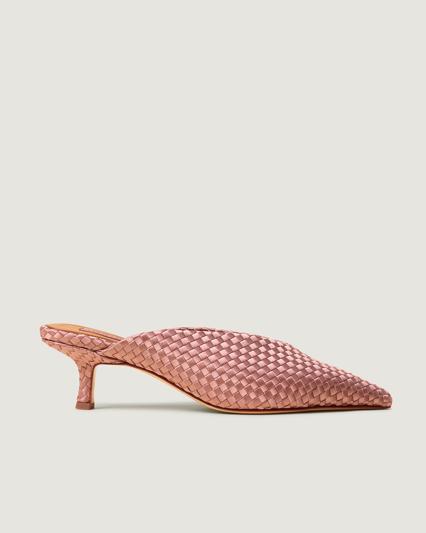 Side view of Strada Satin Kitten Heel in Daphne, a coral pink tone, featuring a closed toe and pointed silhouette.
