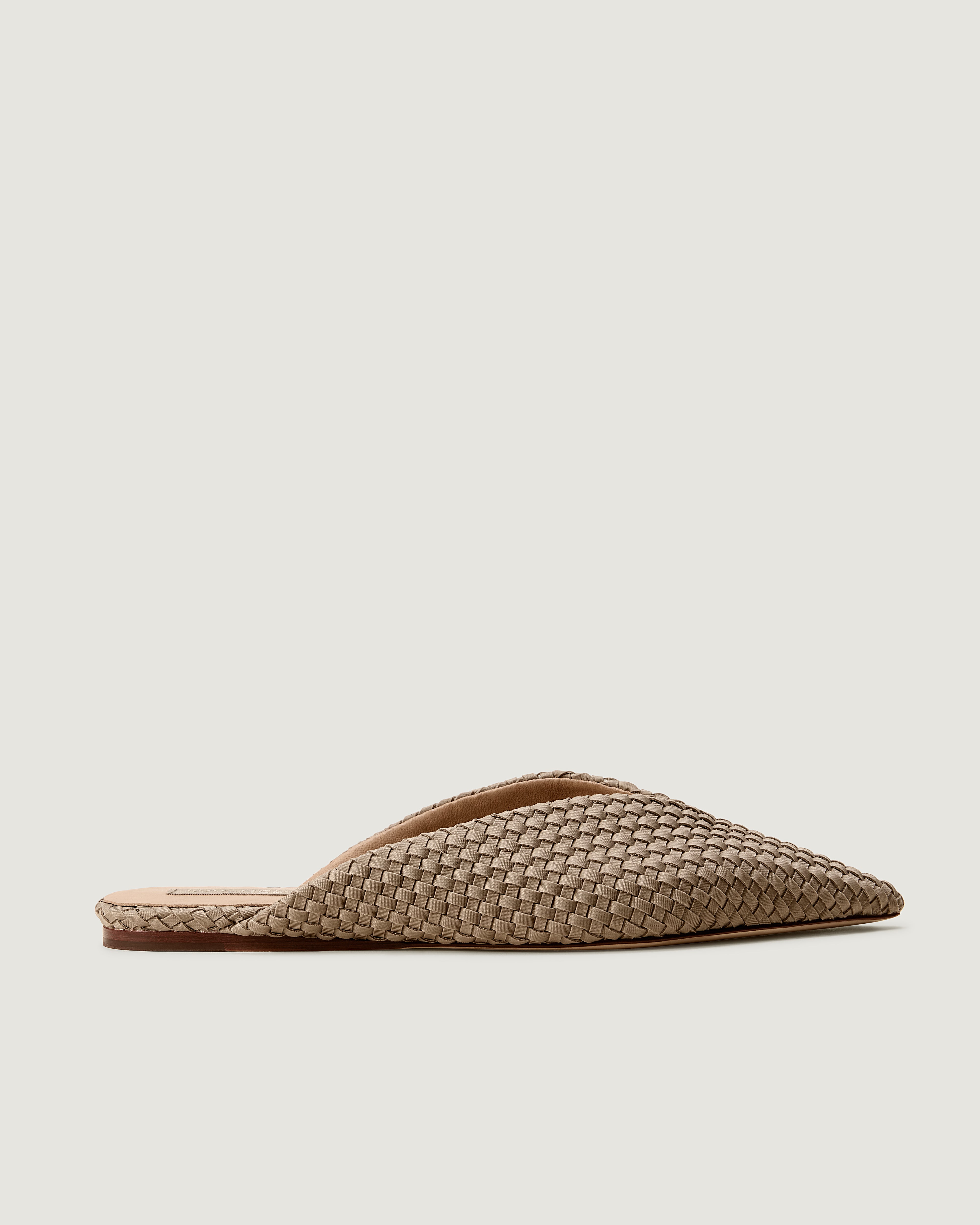 Side view of Strada Mule in Cashmere, a taupe tone, featuring a closed toe and pointed silhouette.