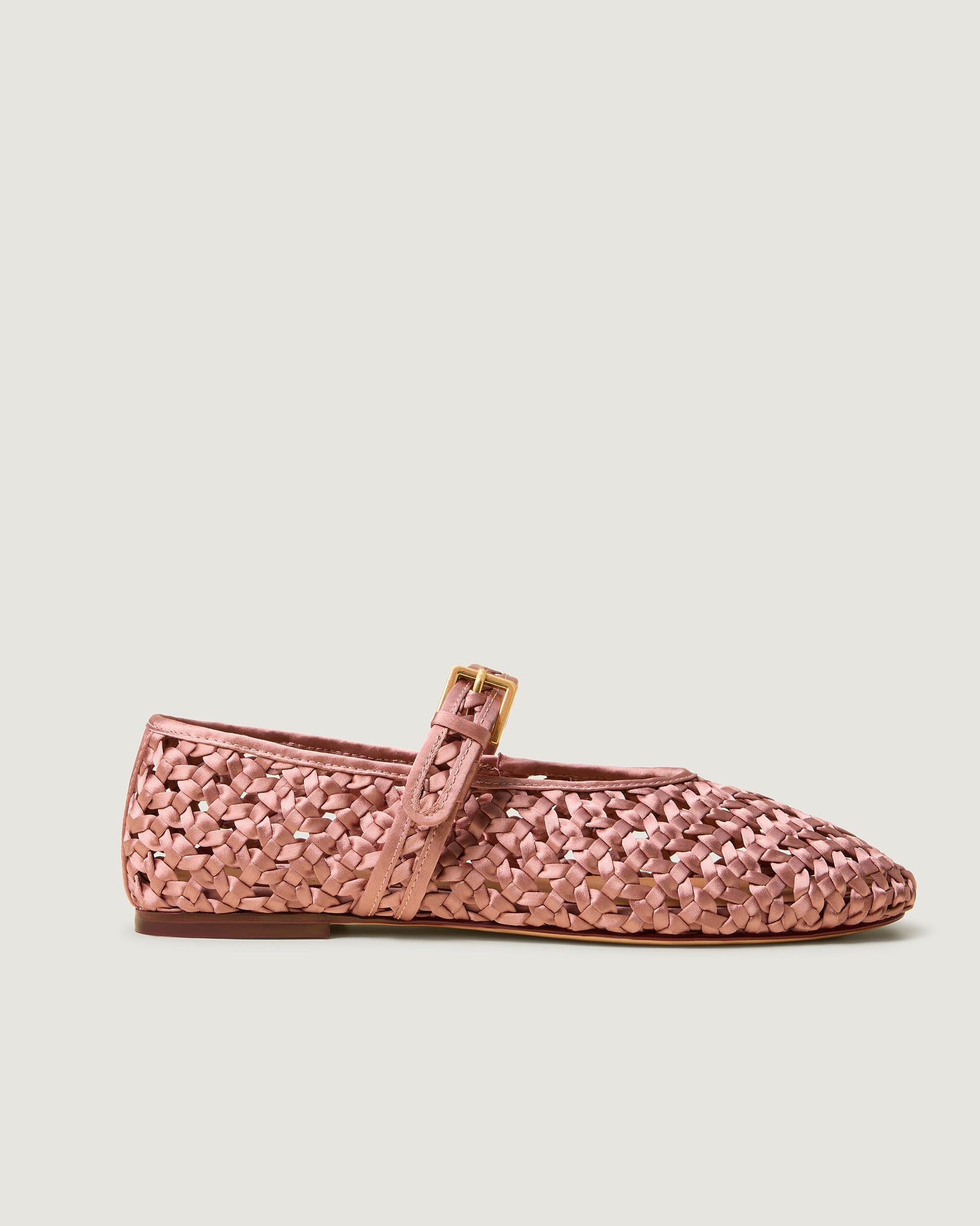 Side view of Sydney Satin Mary Jane Flats in Daphne, a coral pink tone, featuring a closed toe and round silhouette, featuring an adjustable strap with buckle closure.