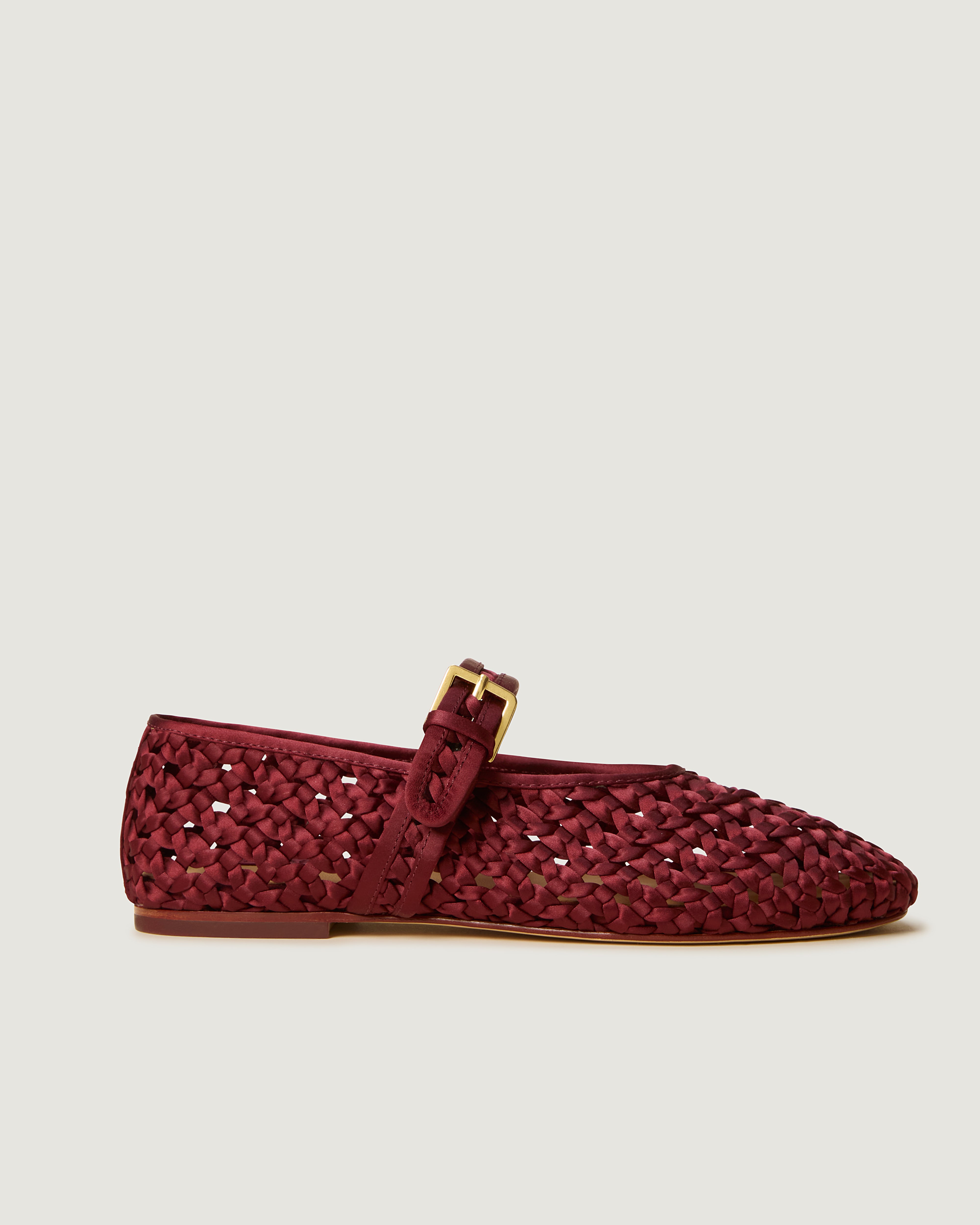 Side view of The Sydney Mary Jane in Garnet, a crimson tone, featuring a closed toe and round silhouette, featuring an adjustable strap with buckle closure.