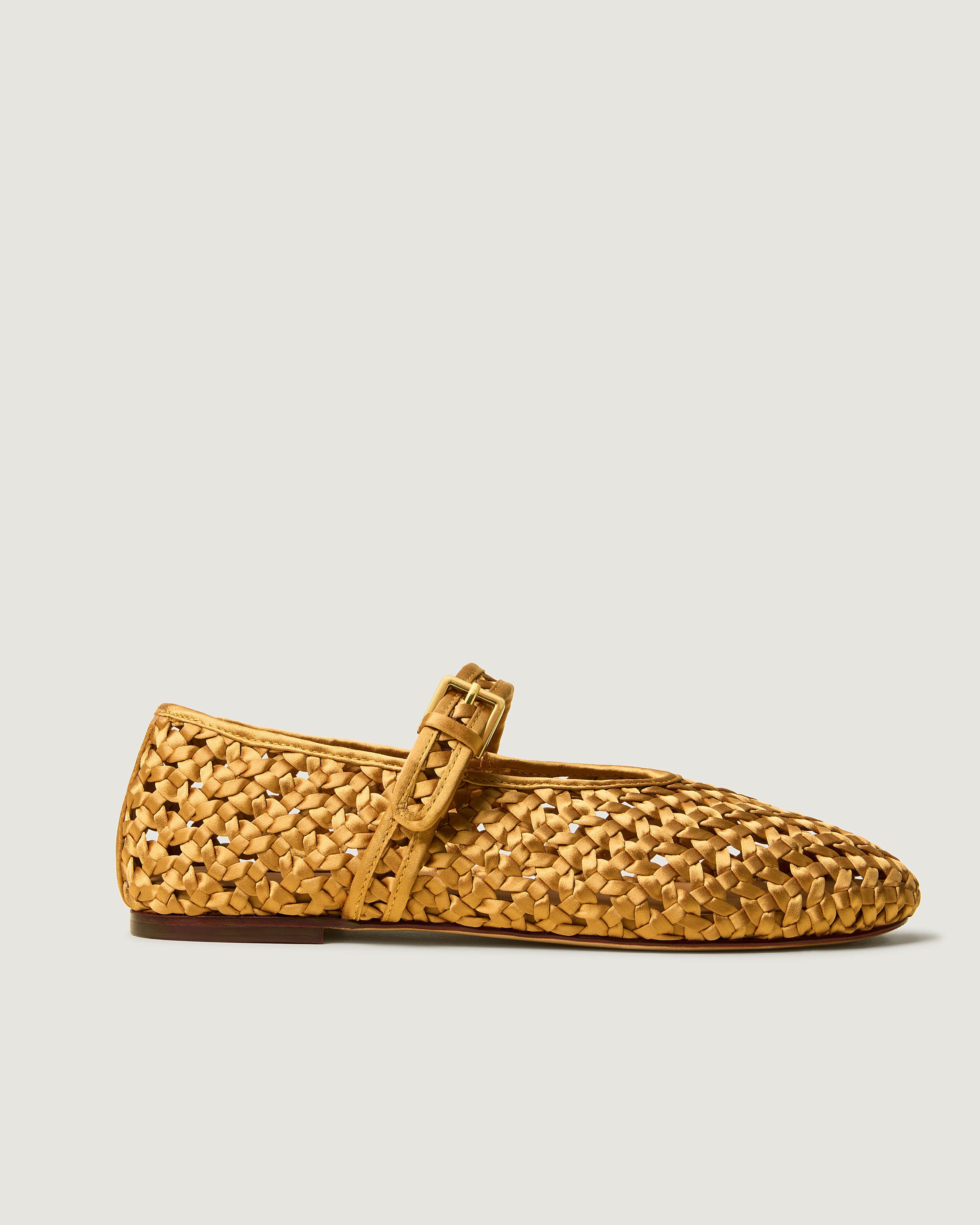 Side view of The Sydney Mary Jane in Ore, a golden yellow tone, featuring a closed toe and round silhouette, featuring an adjustable strap with buckle closure.