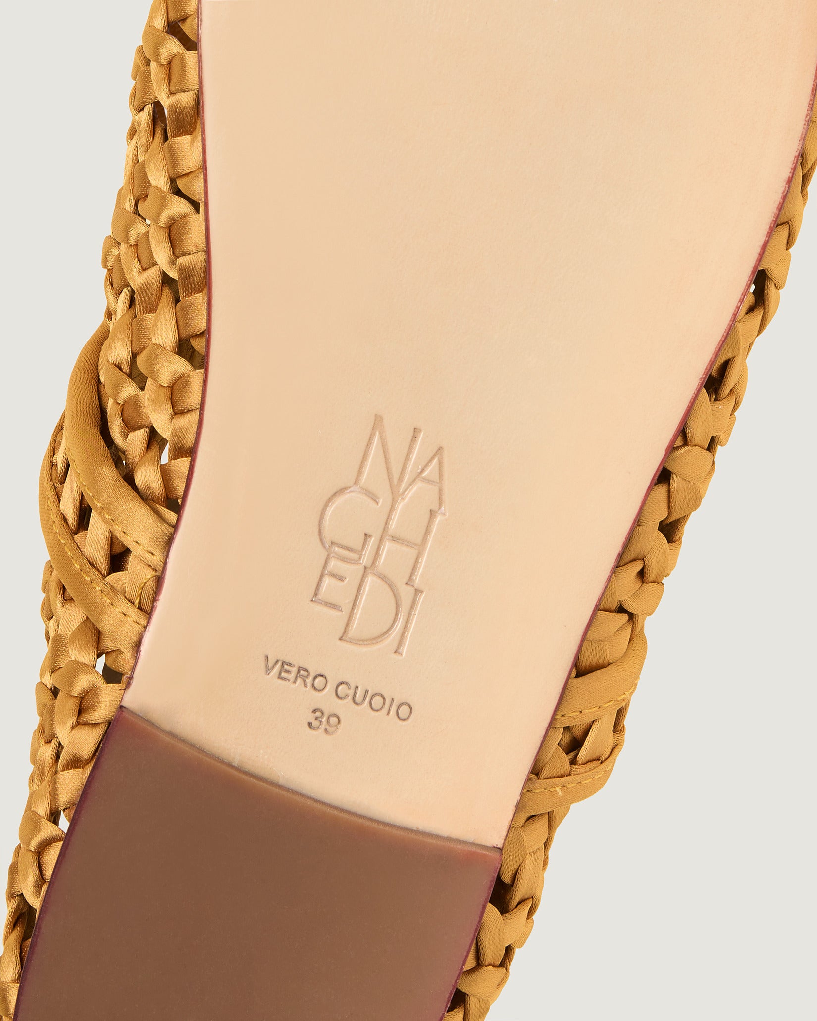 Shoe sole showing natural buffed leather sole, stamped NAGHEDI logo and size detail for Sydney Satin Mary Jane Flats in Ore.
