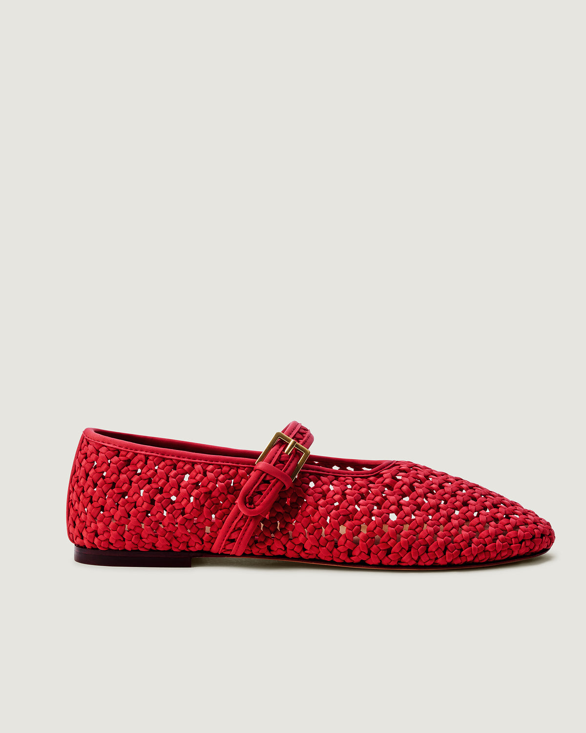 Side view of The Sydney Mary Jane in Cerise, a bright cherry red tone, featuring a closed toe and round silhouette, featuring an adjustable strap with buckle closure.