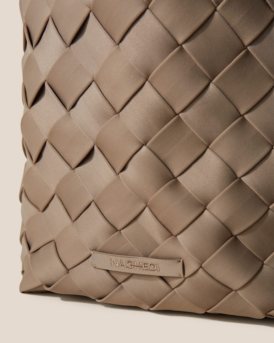 Close-up of stamped NAGHEDI logo on Tangier Tote in Cashmere.