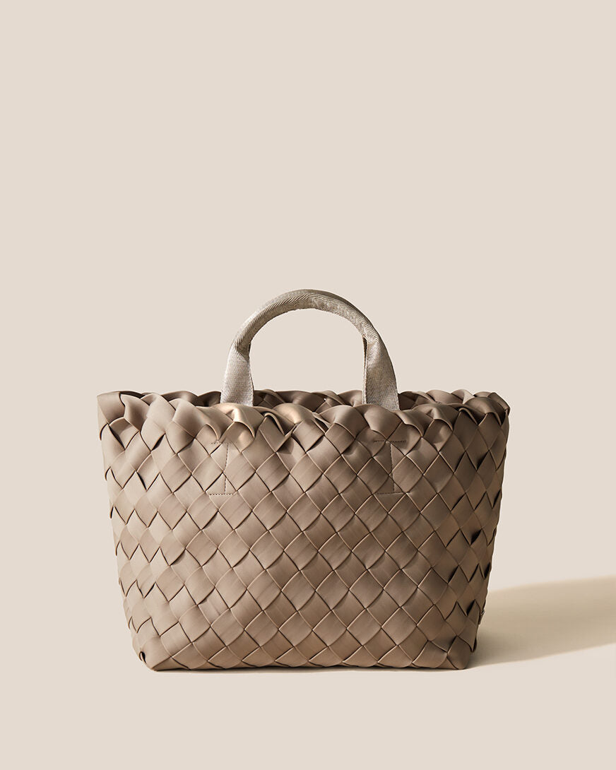 Tangier Tote in Cashmere, a taupe tone, in handwoven neoprene, featuring an open top, and sleek nylon webbing handles.