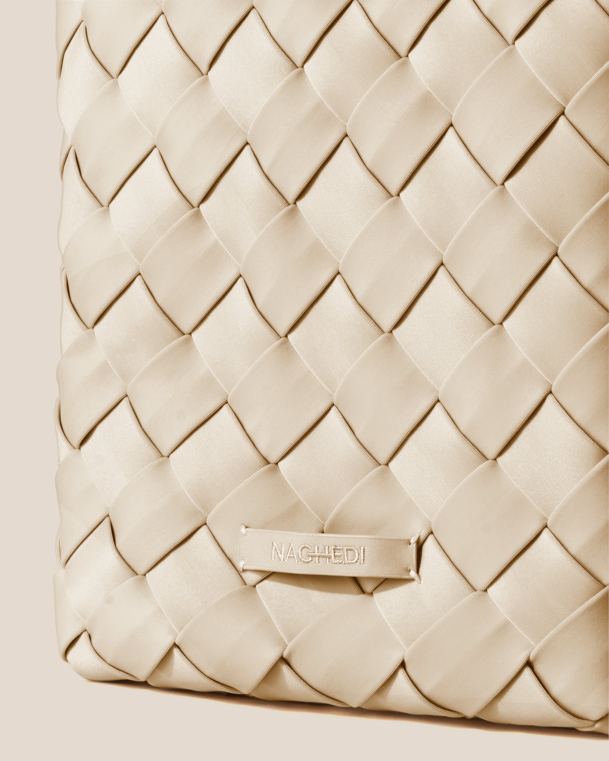 Close-up of stamped NAGHEDI logo on Tangier Tote in Ecru.