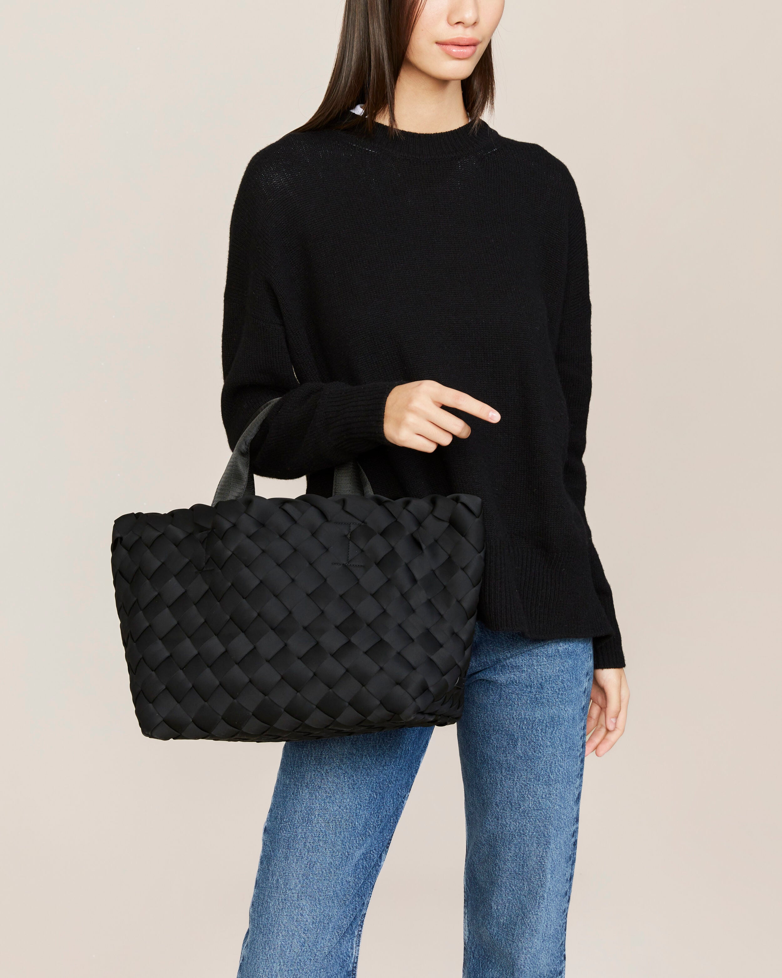 Tangier Tote in Onyx shown on model to illustrate scale and soft silhouette.