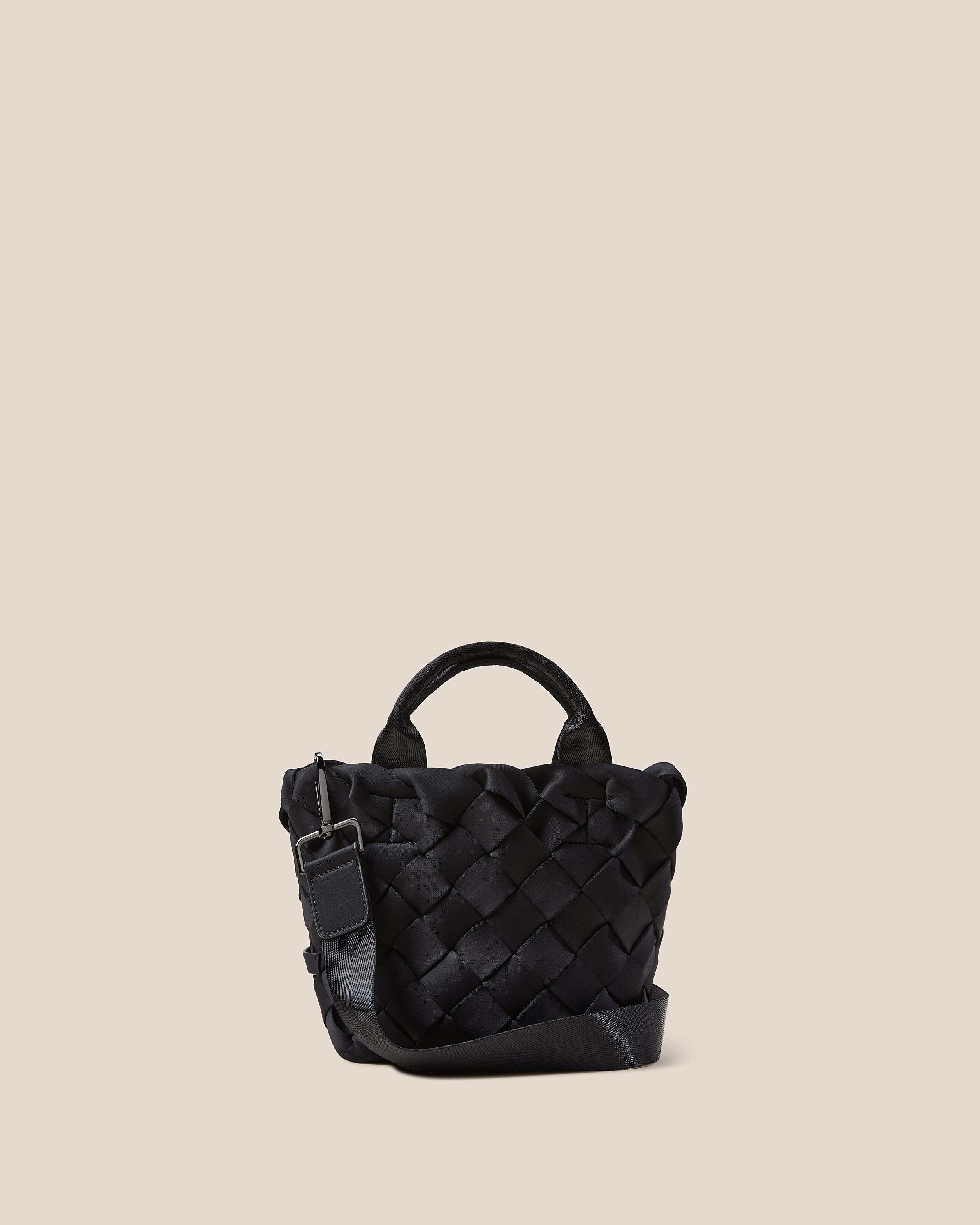 Tangier Tote in Onyx, a true black tone, in handwoven neoprene, featuring an open top, sleek nylon webbing handles, and detachable, adjustable nylon crossbody strap.