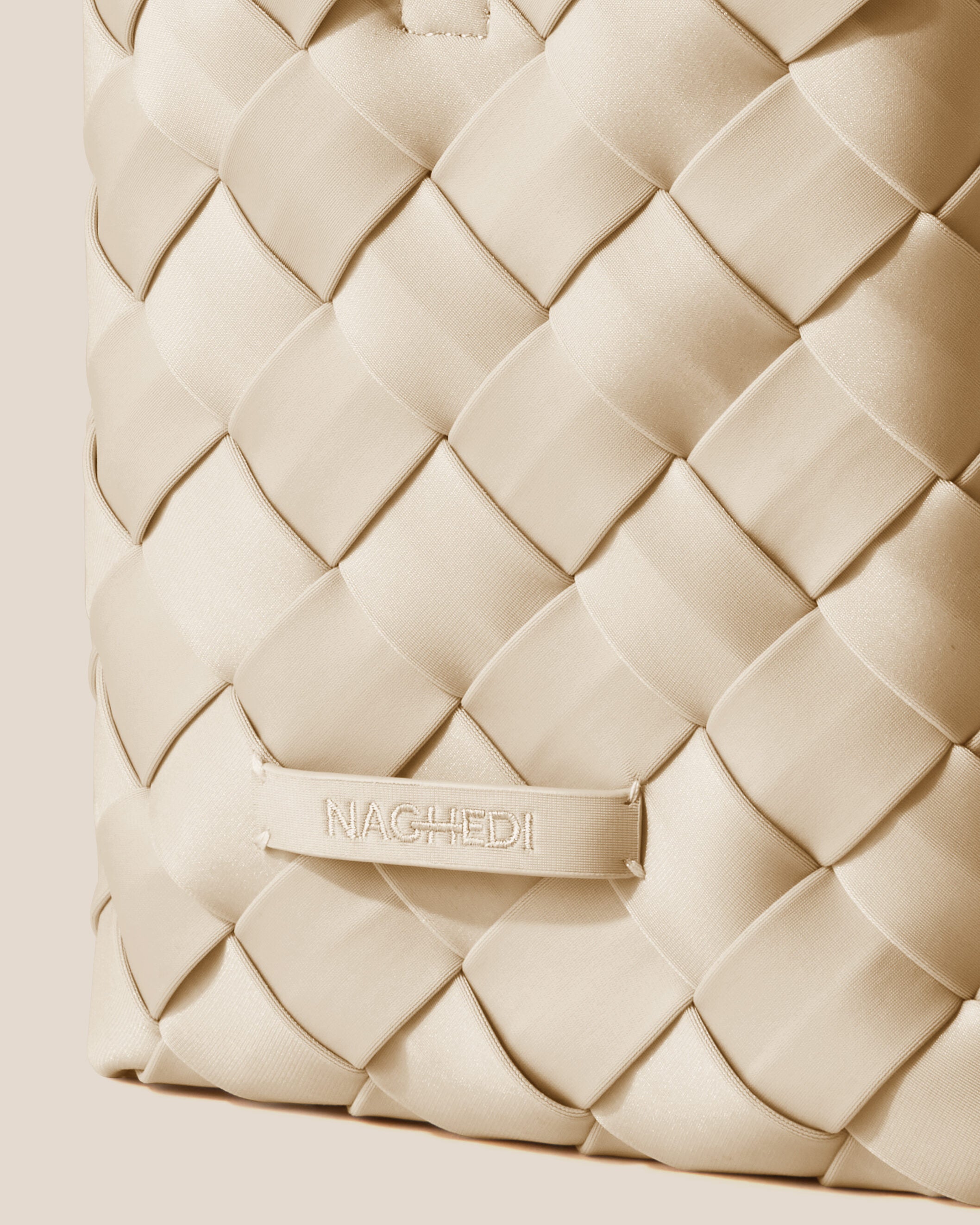 Close-up of stamped NAGHEDI logo on Tangier Tote in Ecru.