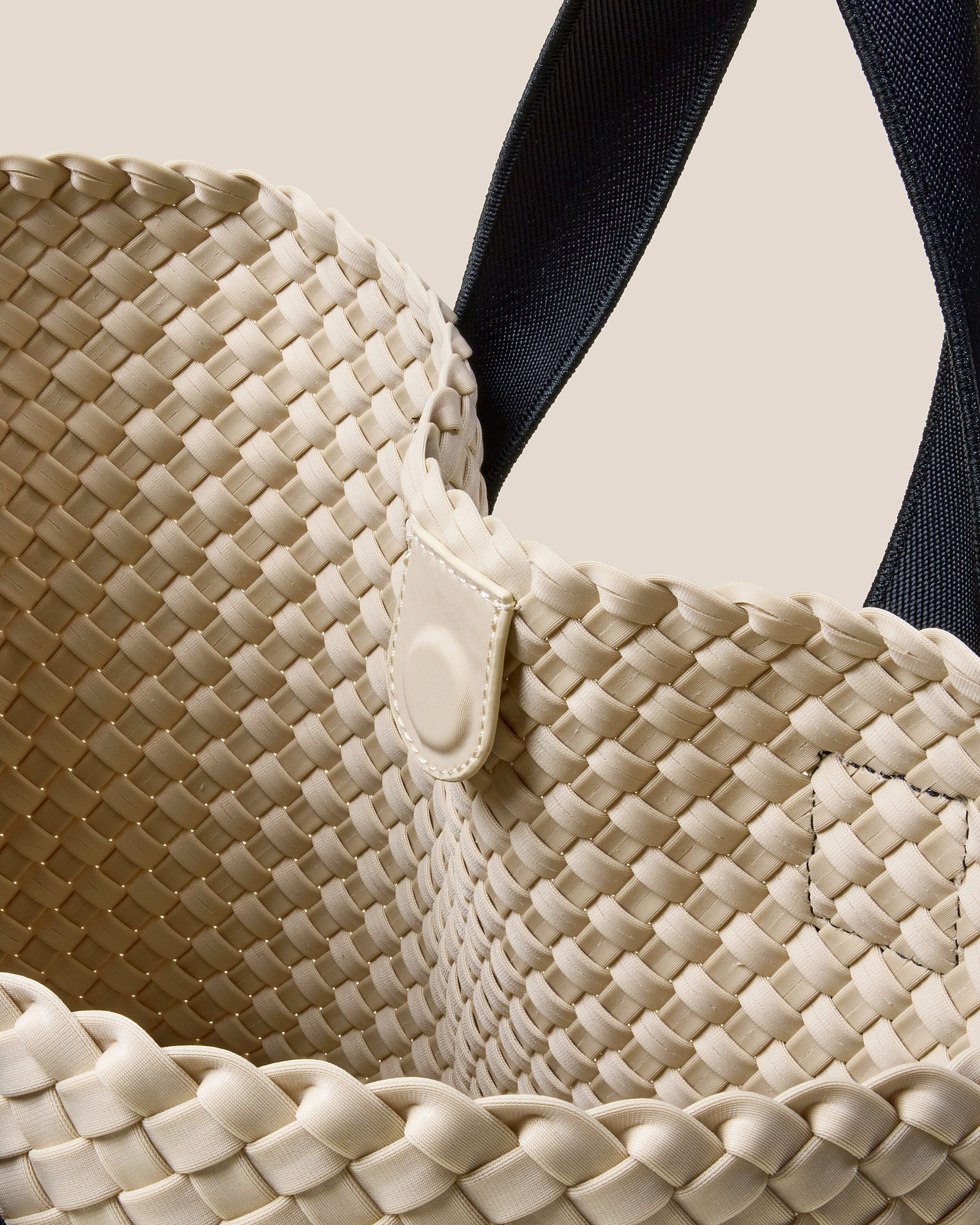 Interior close-up of Tulum Tote in Moon showing its open top with magnetic snap closure, and unlined interior.