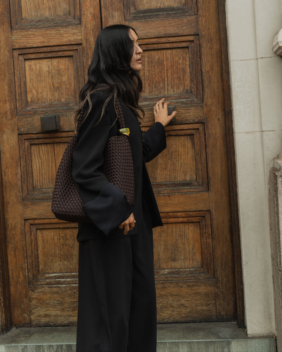 Woman wearing Nomad Medium Hobo with Beads in Chocolate over her shoulder demonstrating soft silhouette and handwoven design