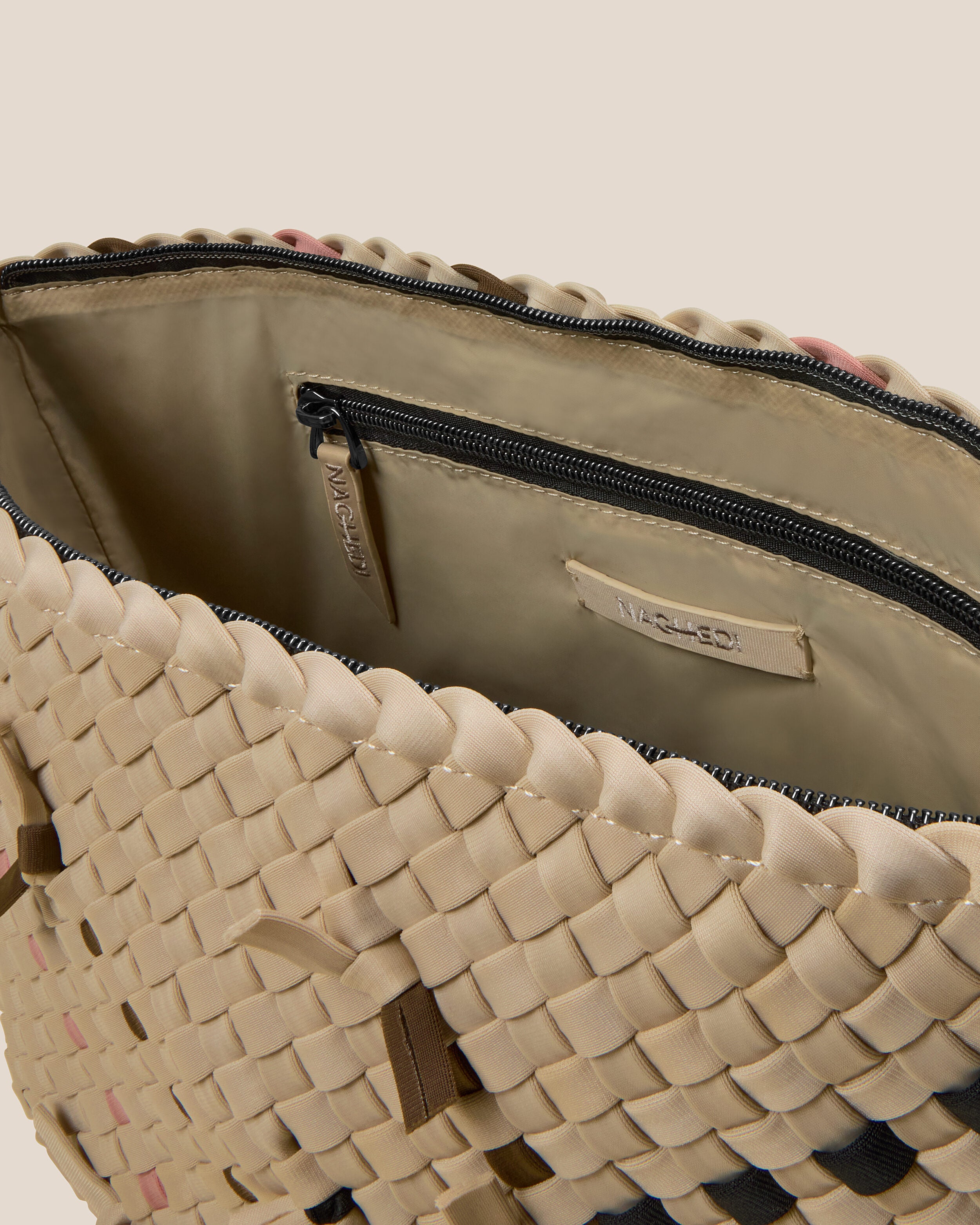 Interior close-up of Portofino Cosmetic Pouch in Quartz showing its zip closure, interior pockets, and wipe-clean nylon interior.