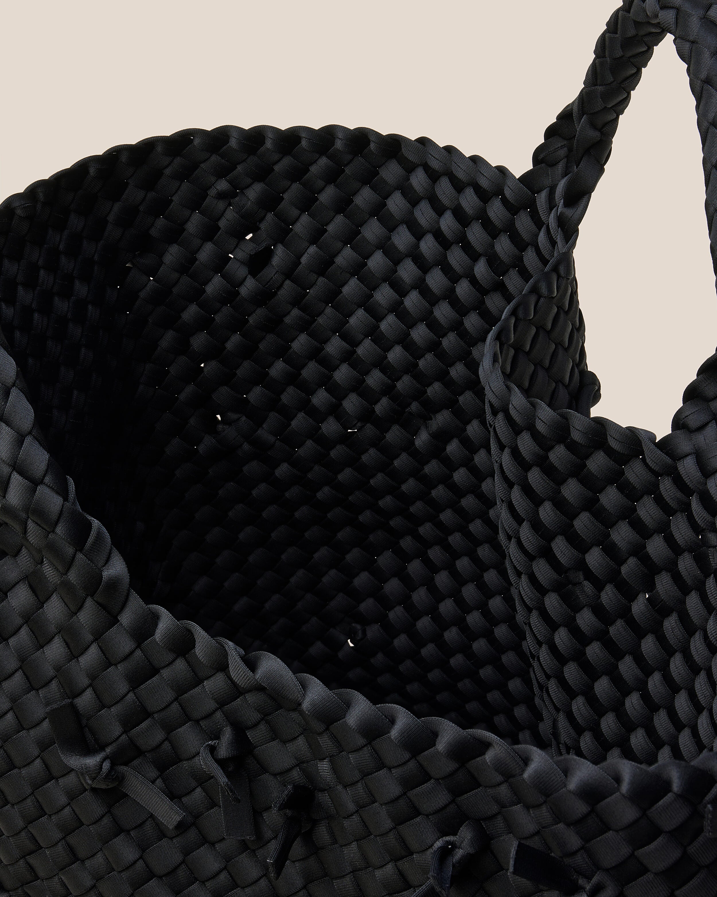 Interior close-up of St. Barths Tote in Onyx showing its open top, and unlined interior.