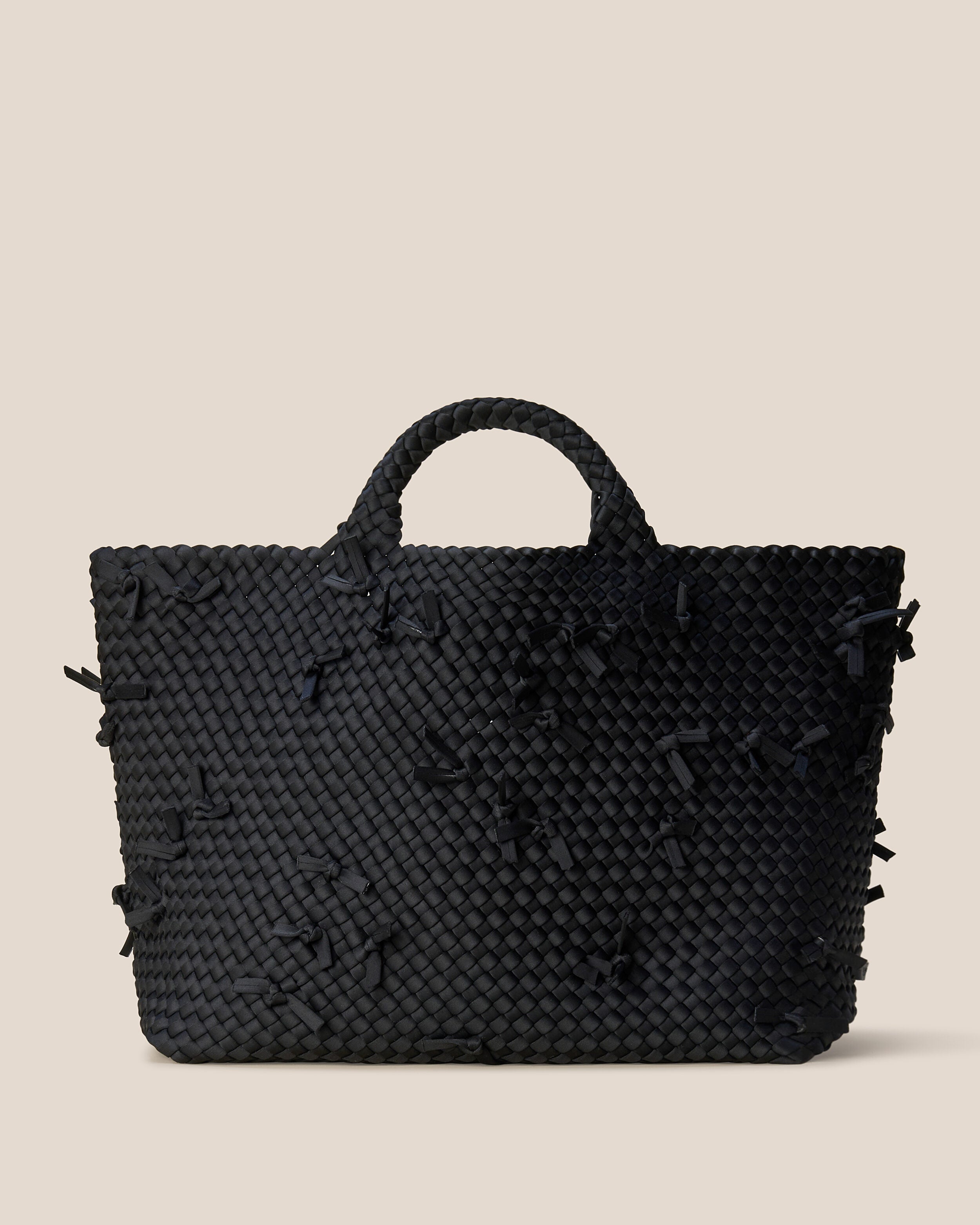 St. Barths Tote in Onyx, a true black tone, in handwoven neoprene, featuring an open top, and woven top handles.