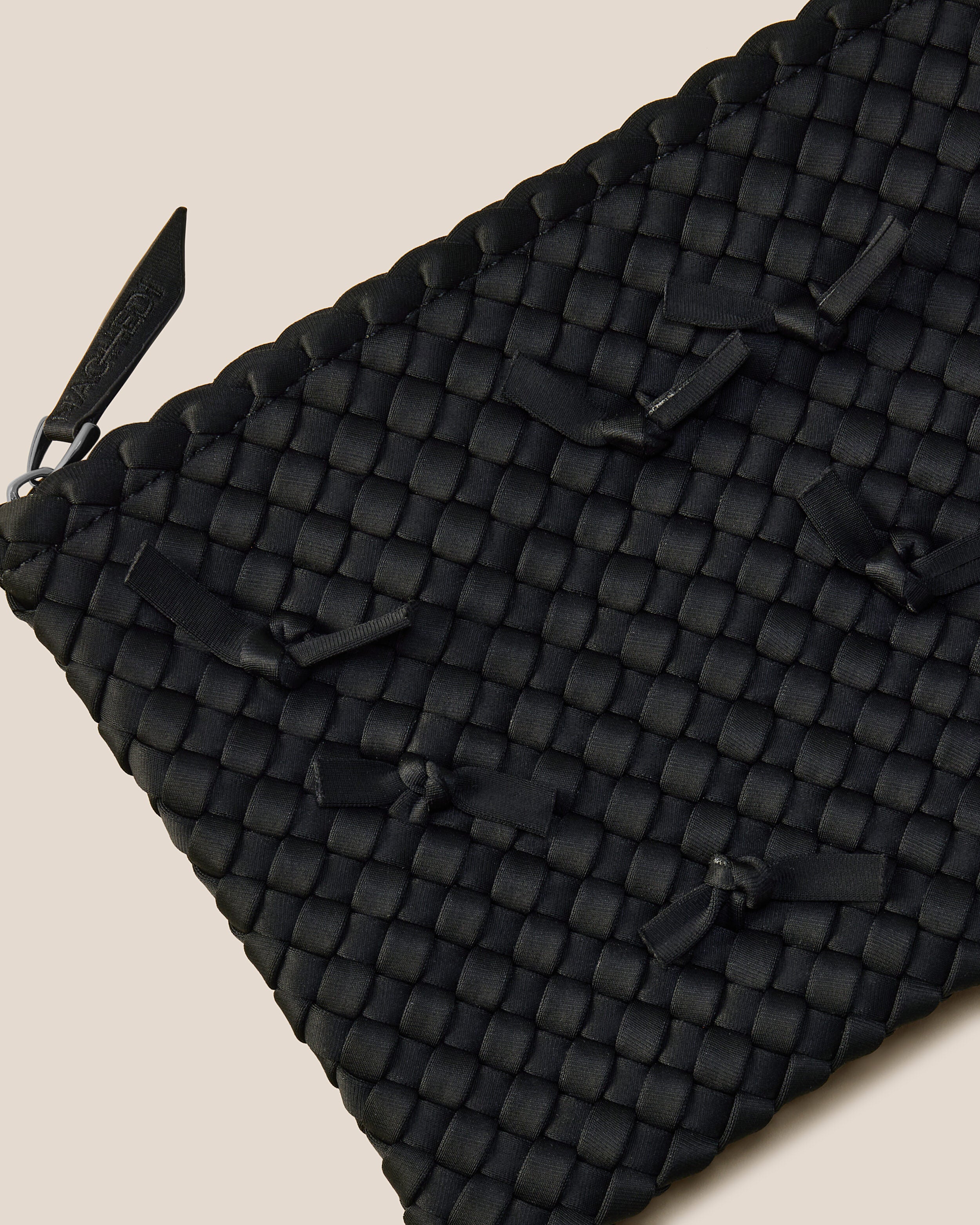 Close-up of included matching woven zippered pouch.