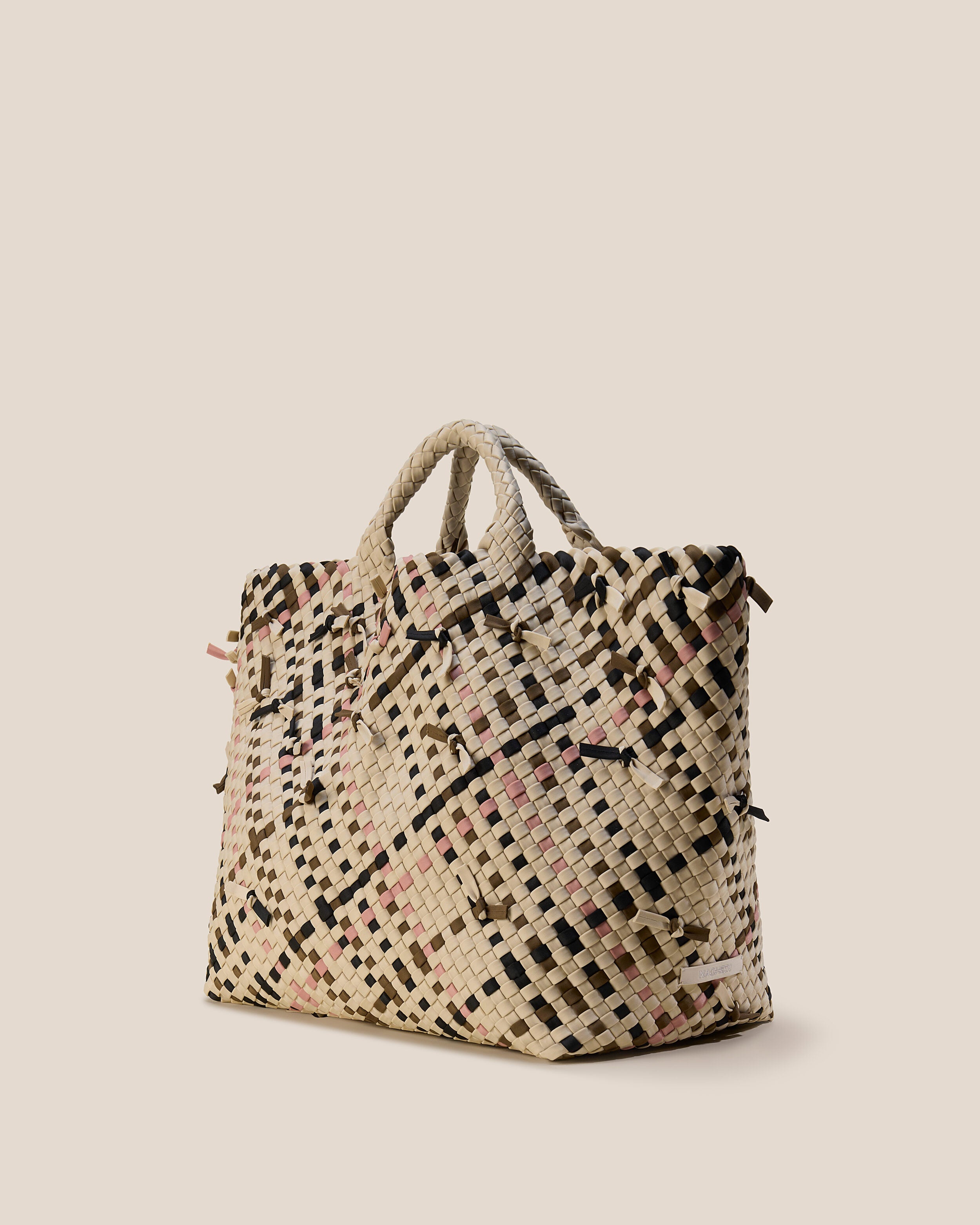 St. Barths Tote in Quartz shown from a side angle, highlighting its handwoven neoprene construction and open top.