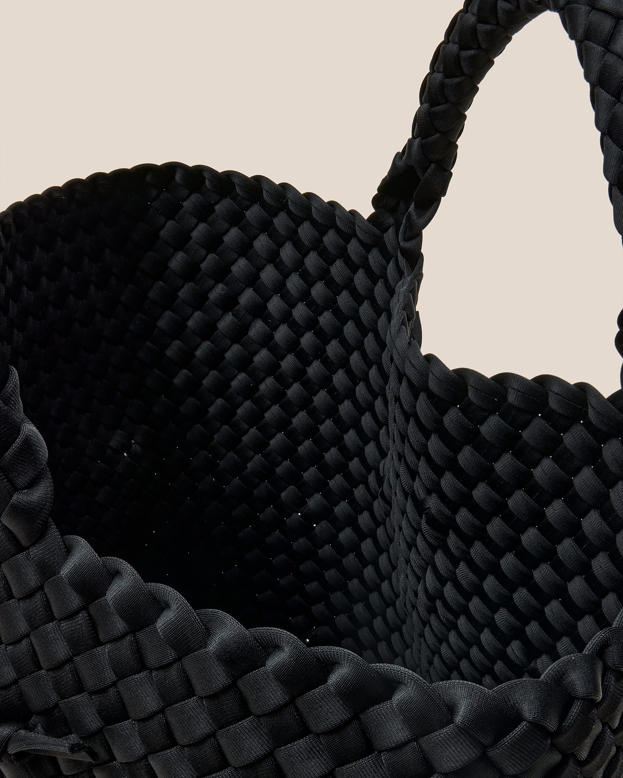 Interior close-up of St. Barths Tote in Onyx showing its open top, and unlined interior.