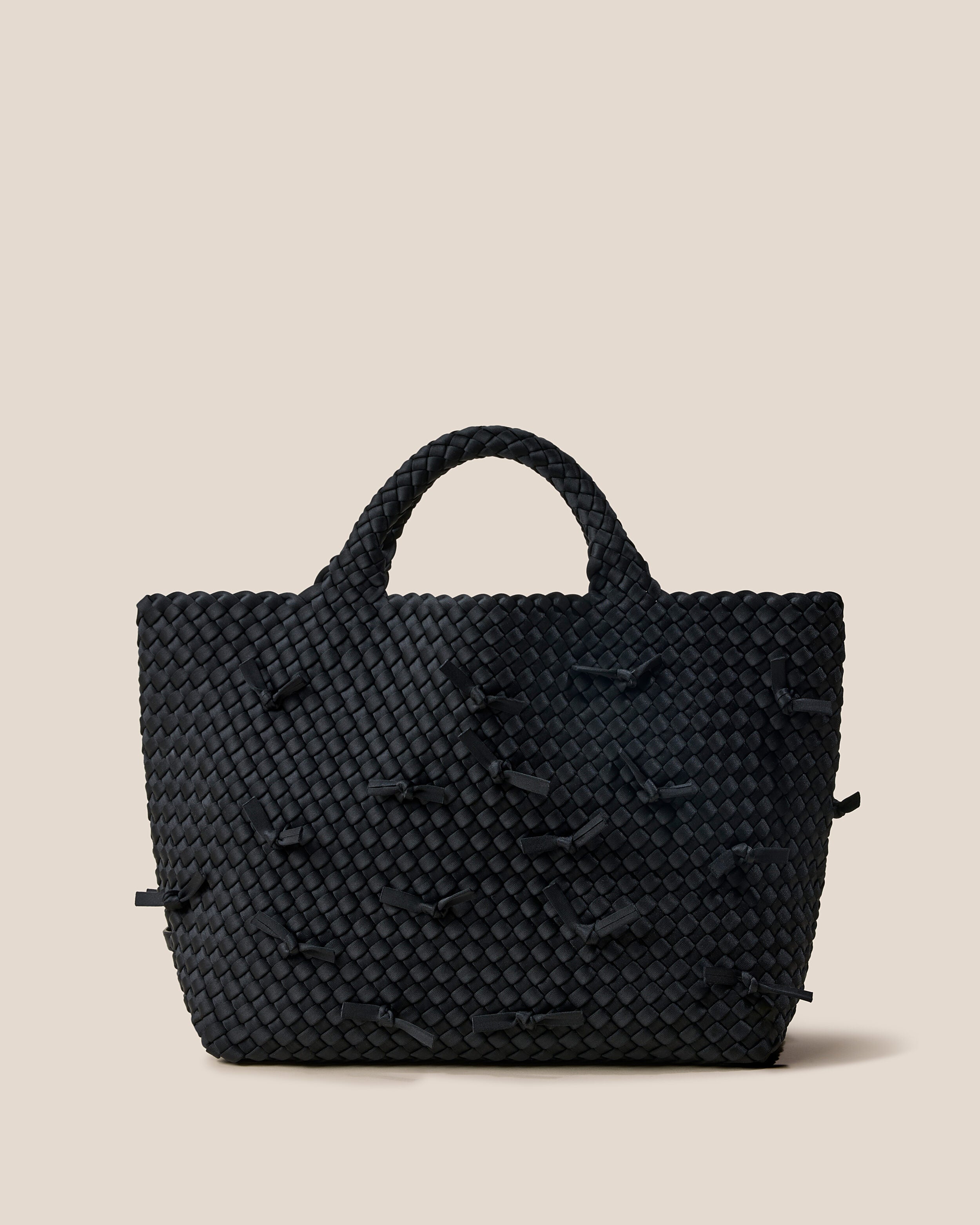 St. Barths Tote in Onyx, a true black tone, in handwoven neoprene, featuring an open top, and woven top handles.